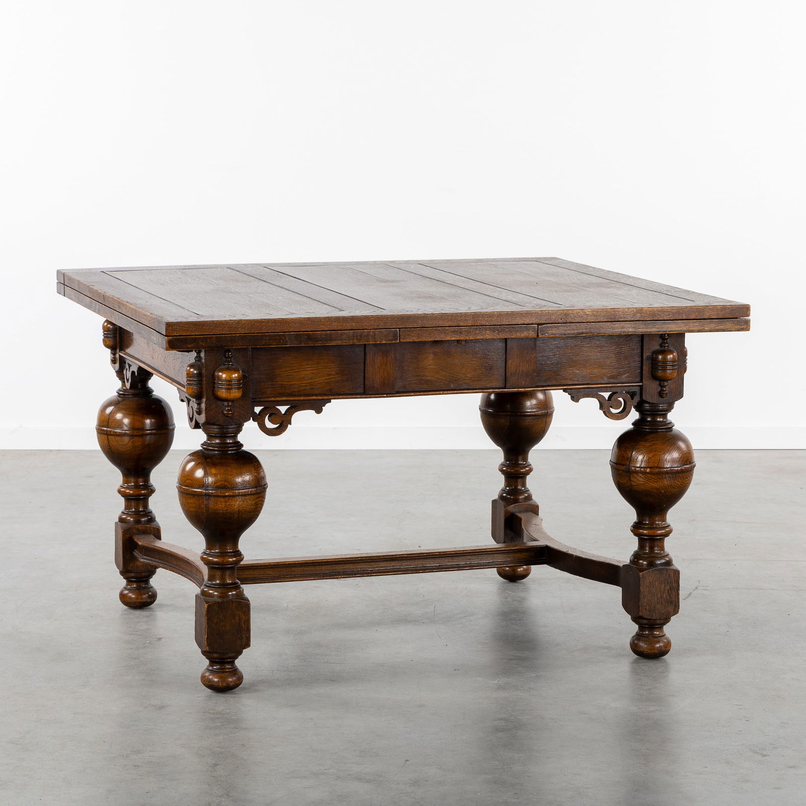 An Oak Extendable Ball-Leg Table, Renaissance style, 19th C.: An Oak Extendable Ball-Leg Table, Renaissance style, 19th century. Sculptured oak.Table with baluster legs and Y-shaped cross joints.Renaissance style, 19th century. Dimensions of extended table: 212