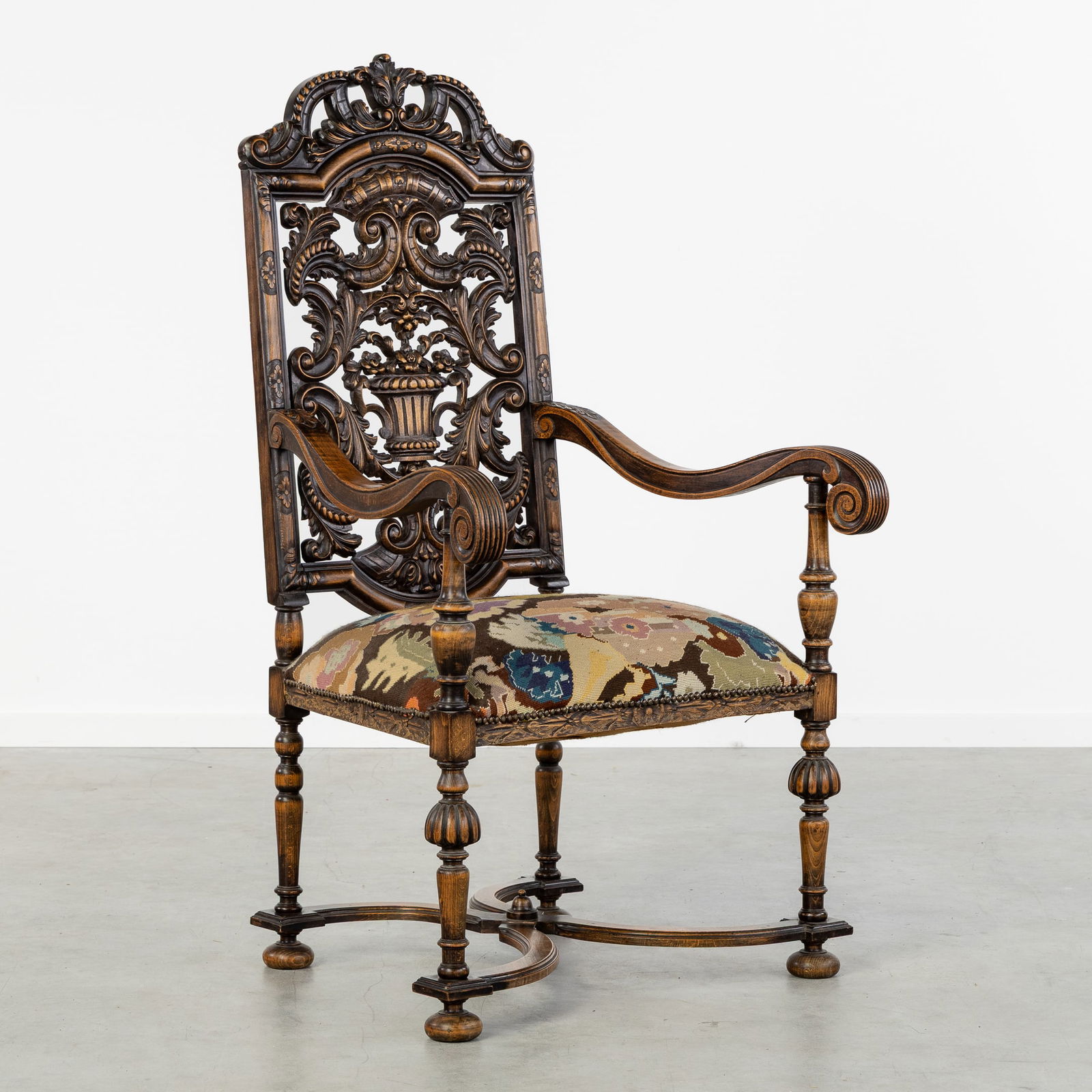A Richly Sculptured Throne Chair with Embroidery, Neo-Renaissance style, 20th C.: A Richly Sculptured Throne Chair with Embroidery, Neo-Renaissance style, 20th century. Sculptured wood.Decorated with scrolls and a flower basket.Seat covered with embroidery.Neo-Renaissance style,