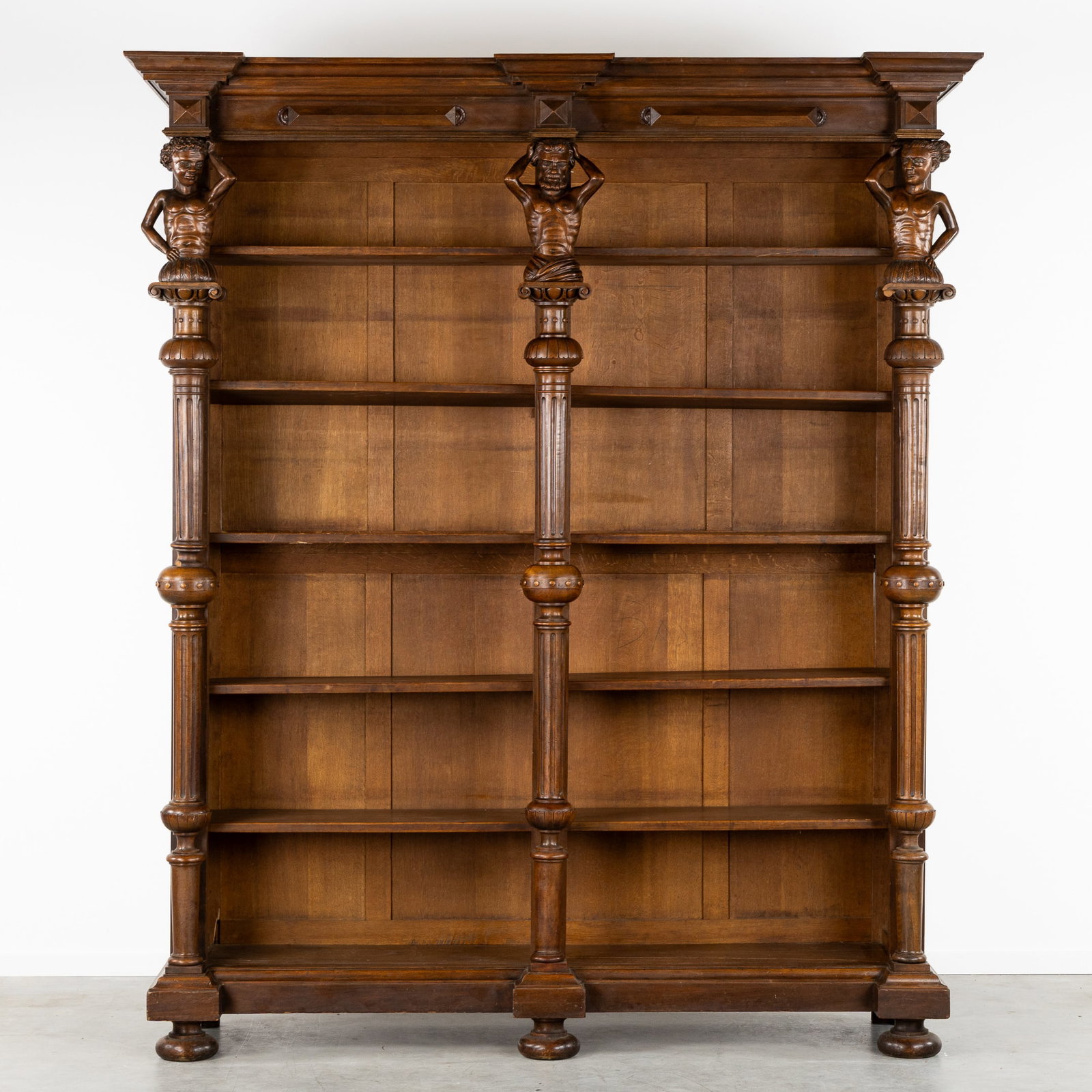 An Impressive Library Case with Sculptured Columns and Atlantes, Neo-Renaissance Style, circa 1900.: An Impressive Library Case with Sculptured Columns and Atlantes, Neo-Renaissance Style, circa 1900. Large library or bookcase with 5 shelves.Decorated with three wood-sculptured columns topped with