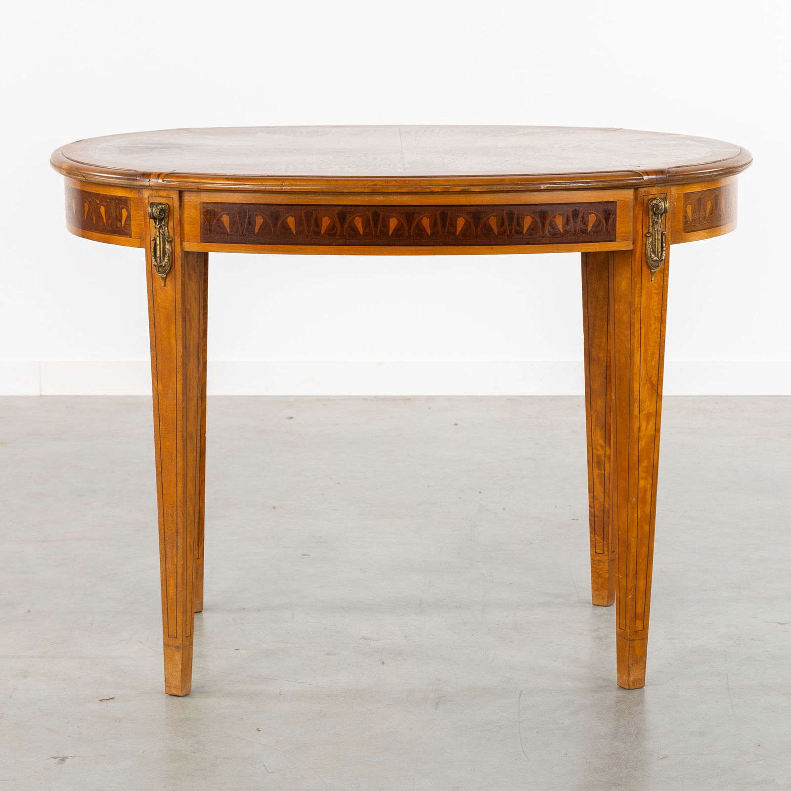 Maison Franck, An Art Nouveau Side Table, Marquetry and Burl Wood Veneer, Antwerp, circa 1920.: Maison Franck, An Art Nouveau Side Table, Marquetry and Burl Wood Veneer, Antwerp, circa 1920.An oval side table.Decorated with floral marquetry, burl wood veneer, and bronze fittings.Attributed