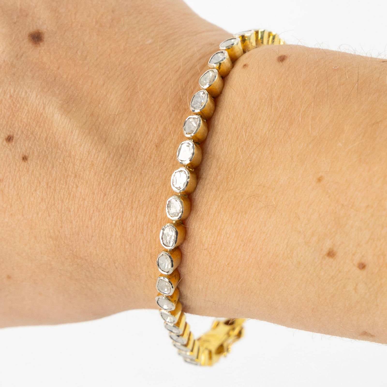 A bracelet, gold-plated silver mounted with a flat-cut diamond. 12.02g.: A bracelet, gold-plated silver mounted with a flat-cut diamond. 12.02g. Vermeil (gold-plated silver) mounted with a flat-cut diamond. Total gross weight: 12.02g.Total length: 20cm.