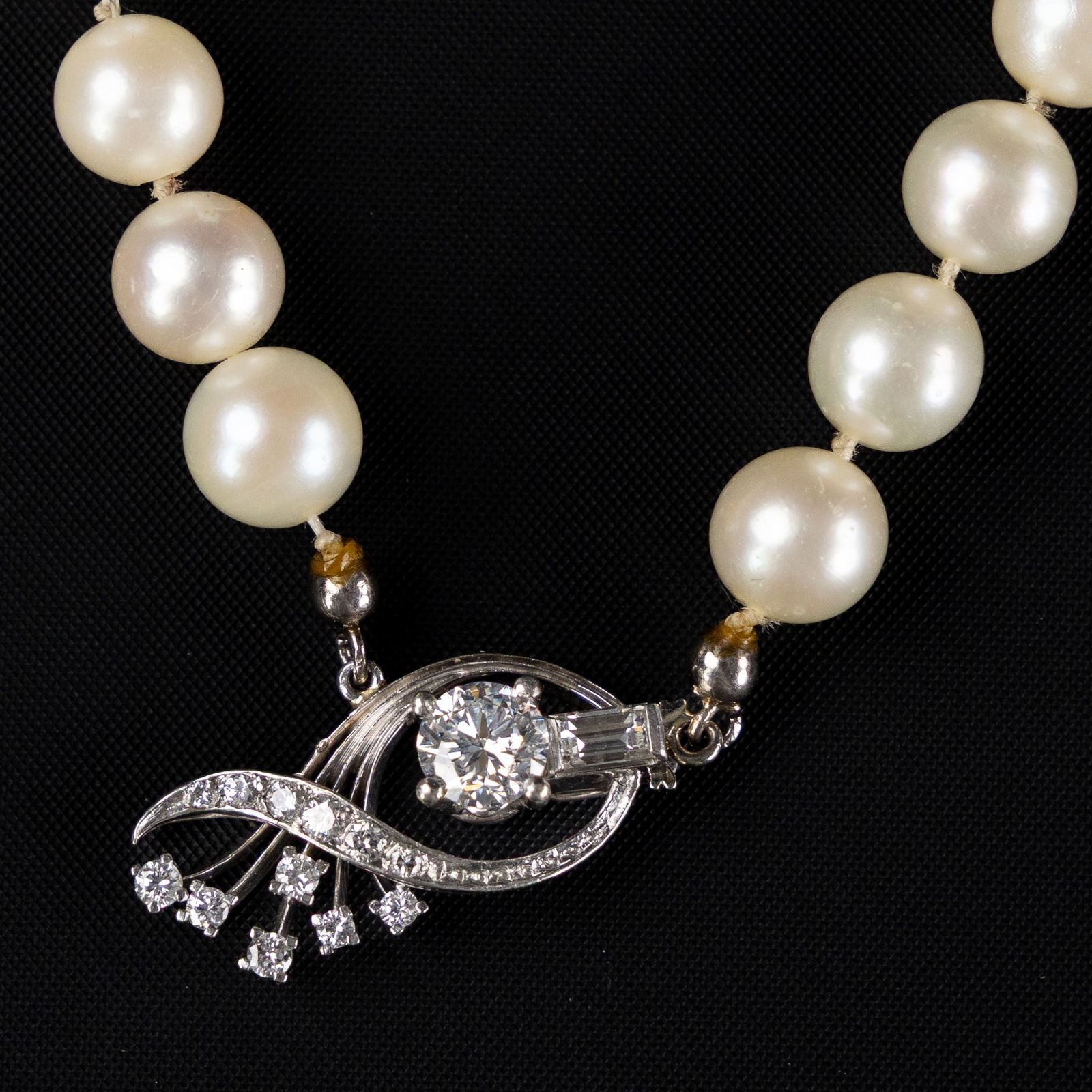 Georg Jensen, necklace, platinum, brilliant-cut and baguette-cut diamonds, cultured pearls. Circa: Georg Jensen, necklace, platinum, brilliant-cut and baguette-cut diamonds, cultured pearls. Circa 1950. A necklace made of cultured pearls, finished with a clasp by Georg Jensen.The lock is made of pl