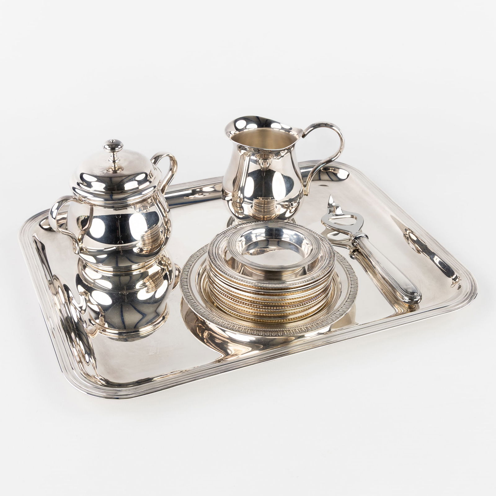 Christofle, A Collection of Tableware, Silver-Plated Metal, with Serving Tray, Milk Jug, Sugar Bowl,: Christofle, A Collection of Tableware, Silver-Plated Metal, with Serving Tray, Milk Jug, Sugar Bowl, Coasters, and a Bottle Opener. Silver-plated metal.1 Serving tray, Albi model (L: 35 cm x W: 27.5