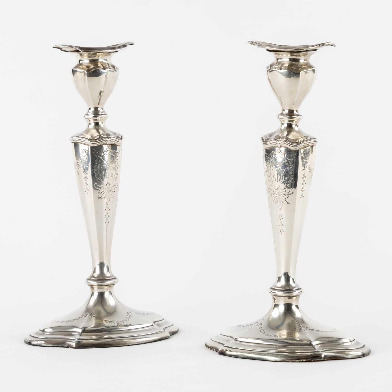 Reed & Barton, A Pair of Silver Candlesticks, Neoclassical Style, United States. Silver.: Reed & Barton, A Pair of Silver Candlesticks, Neoclassical Style, United States. Silver. Silver.A pair of candlesticks, with engraved decorations and the monogram "NRK", Neoclassical style.Marked Ster