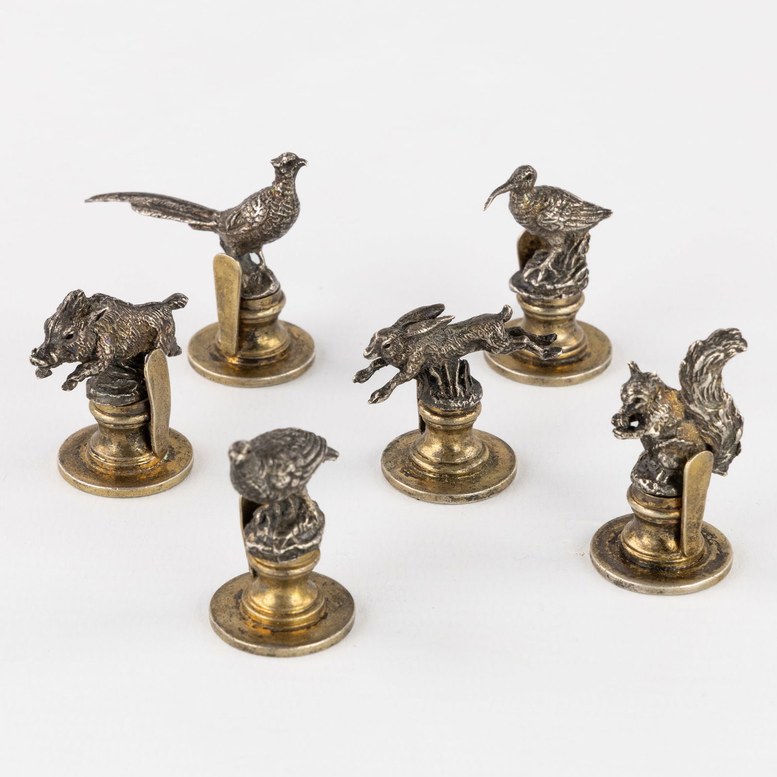 Gucci, A Set of 6 Silver Menu Card Holders with Sculptured Miniature Animals. Silver, 183g.: Gucci, A Set of 6 Silver Menu Card Holders with Sculptured Miniature Animals. Silver. Menu or card holders.With miniature sculptures of game (curlew, squirrel, pheasant, partridge, wild boar, and