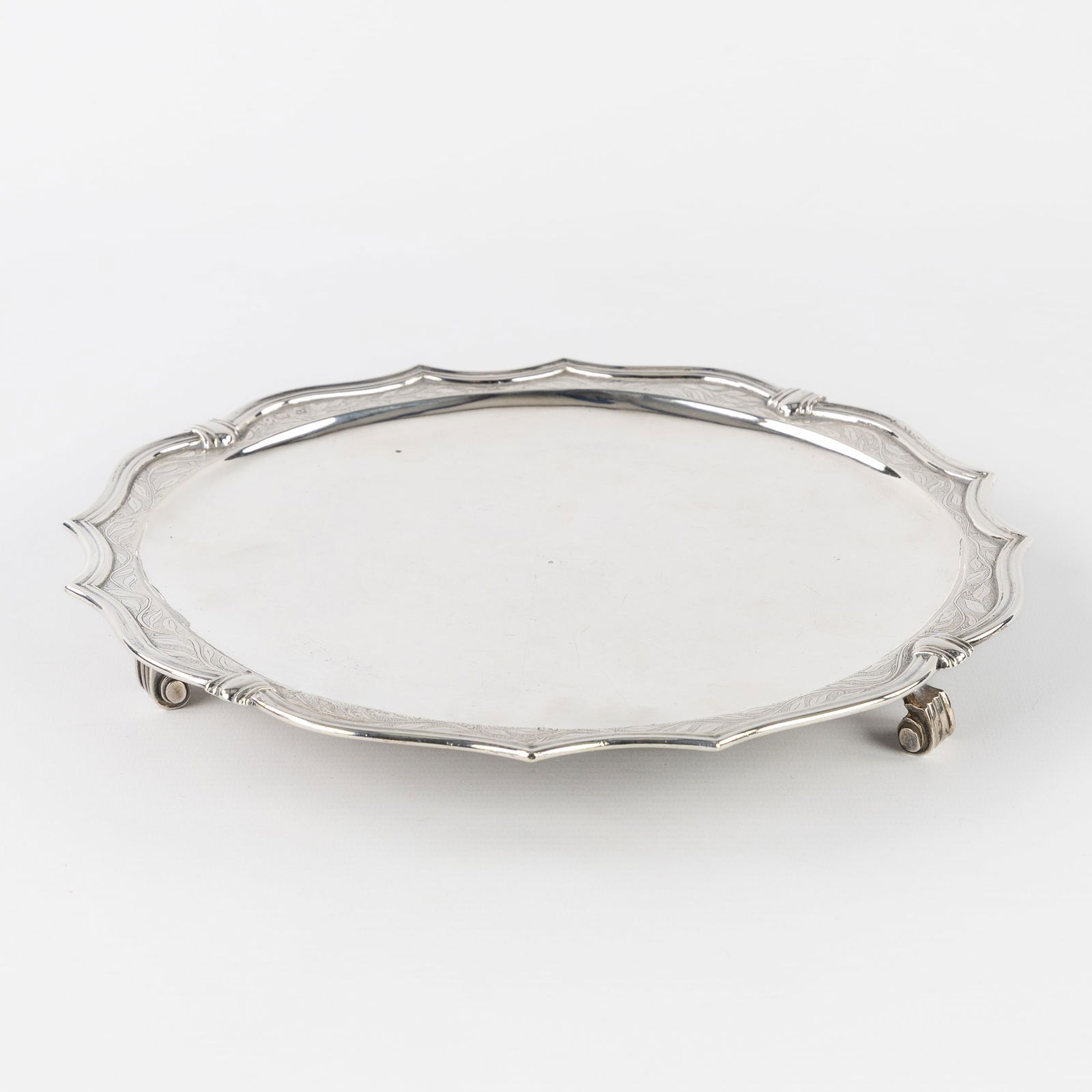 Antoon Van Haecke (act. 1725-c. 1750) An Exceptional Solid Silver 'Assiette Volante', Bruges, 1735.: Antoon Van Haecke (act. 1725-c. 1750) An Exceptional Solid Silver 'Assiette Volante', Bruges, 1735. Silver. A silver assiette volante, decorated with foliate scrolls.City marks for Bruges (crowned
