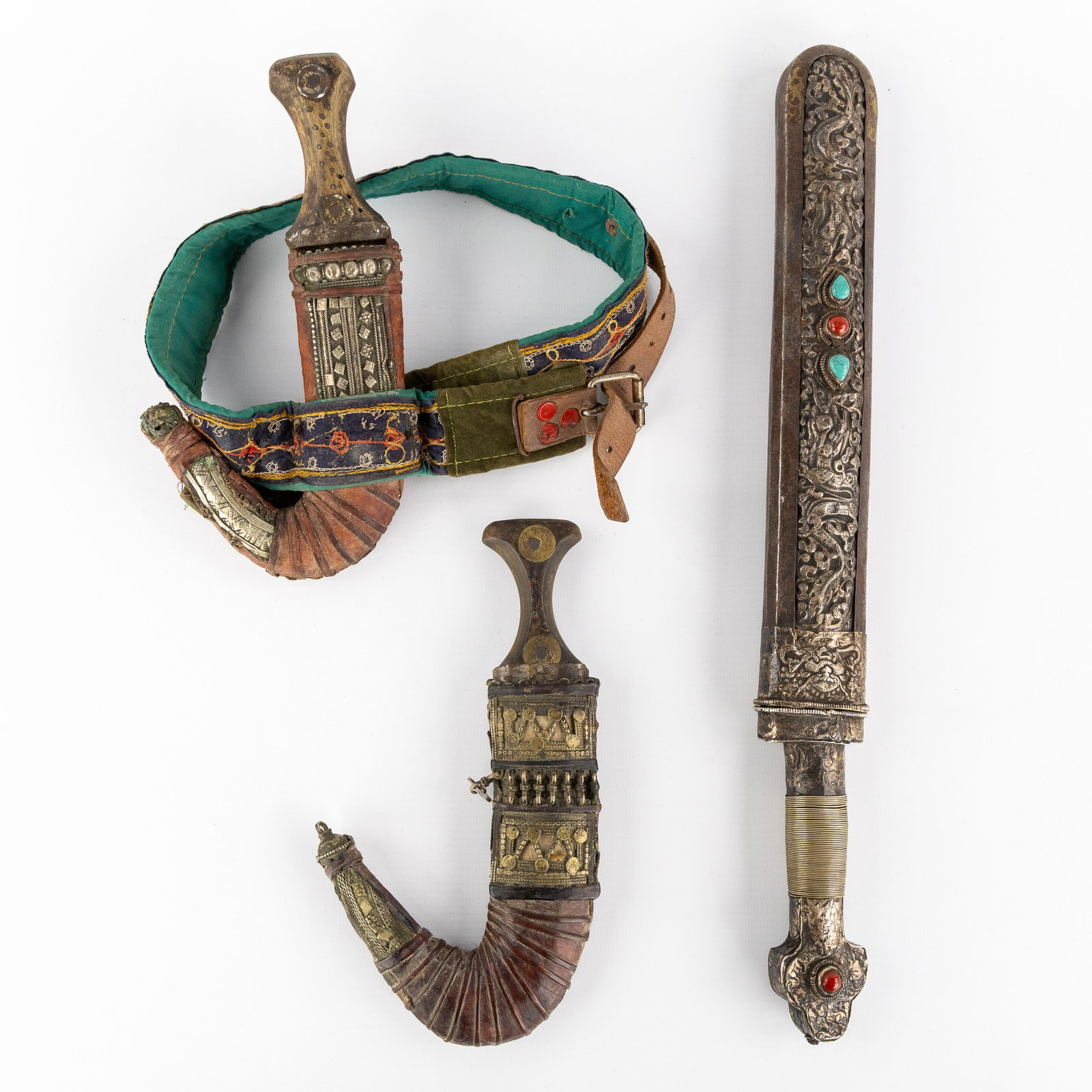 Two Yemeni Jambiya daggers and a Tibetan sword with silver repousse decorations. (1 of 7)