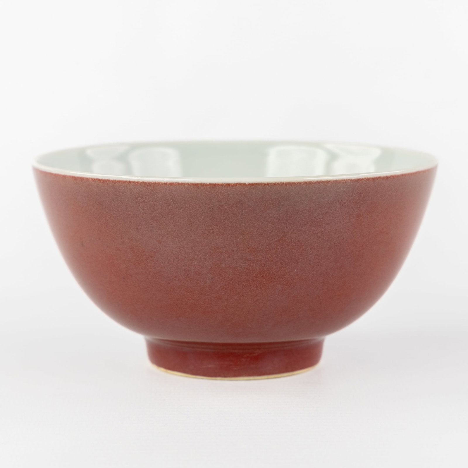 A Chinese monochrome Liver-Red or Sang De Boeuf wine bowl, marked Qianlong.: A Chinese monochrome Liver-Red or Sang De Boeuf wine bowl, marked Qianlong. Chinese porcelain.Marked Qianlong on the bottom. (12.5 x 6.5 x 0 cm)