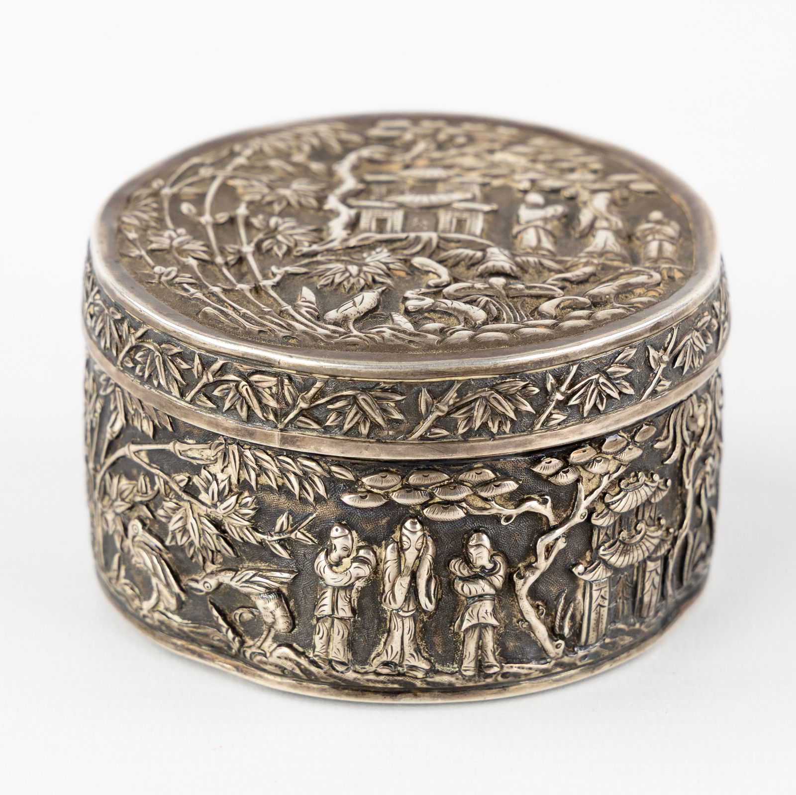 A Chinese silver covered box, decorated with a figurative landscape, circa 1900. Silver, 128g. (1 of 9)