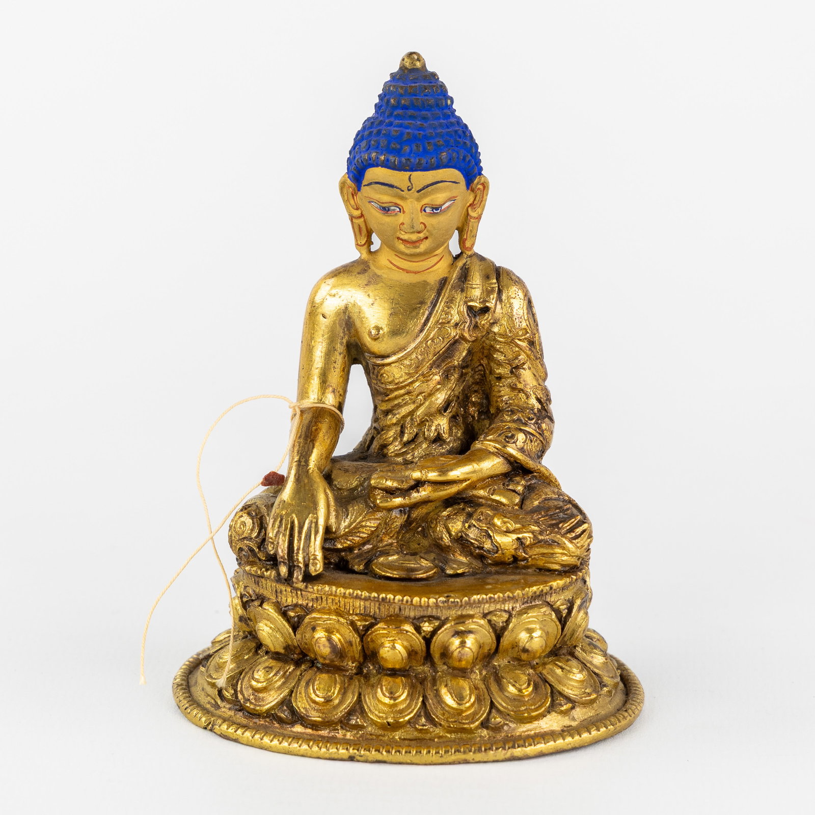A Seated Shakyamuni Buddha, gilded and patinated bronze, 20th C.: A Seated Shakyamuni Buddha, gilded and patinated bronze, 20th century. Gilded and patinated bronze.Shakyamuni or Gautama Buddha. (7.5 x 10 x 6 cm)