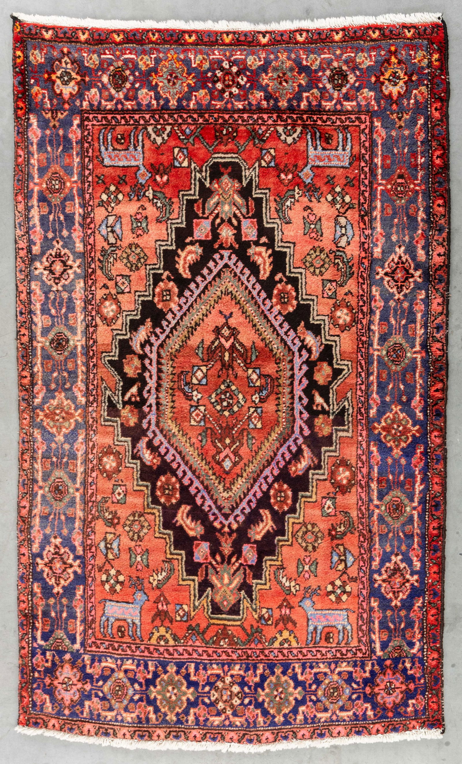An Oriental hand-made carpet, probably Hamadan (201 x 122 cm). (1 of 6)