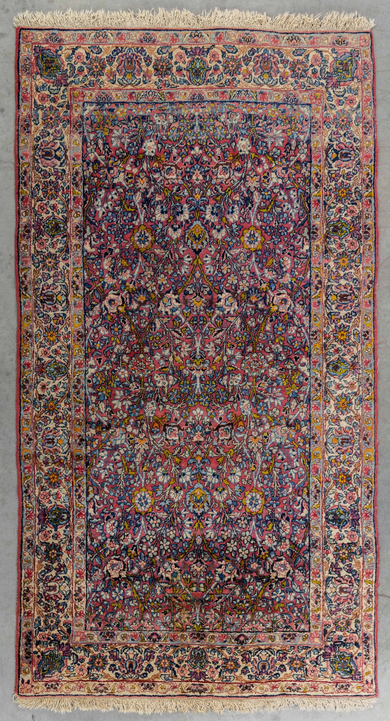 An Oriental hand-made carpet, Kerman (211 x 118 cm). (1 of 5)