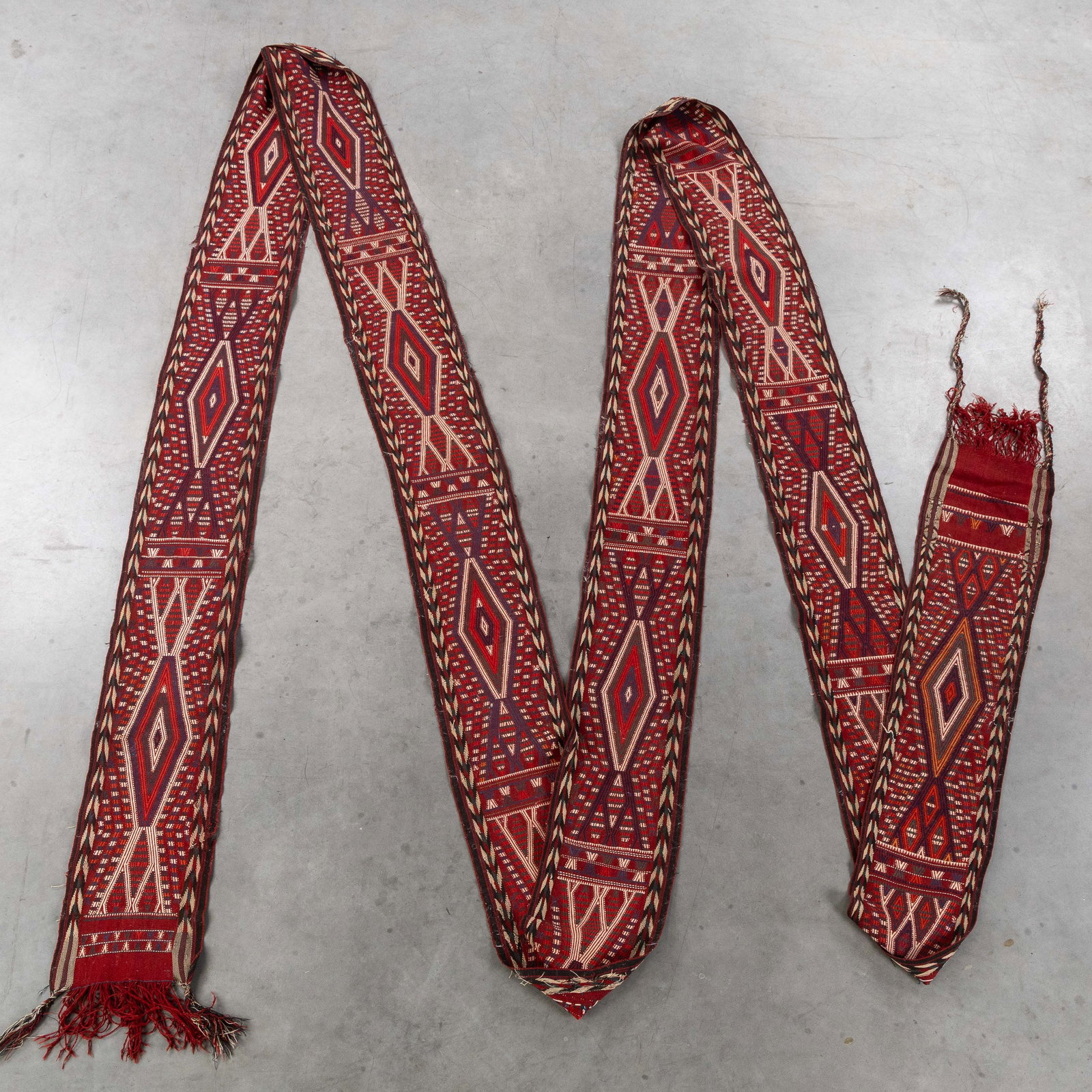 An Oriental hand-made tent strap, Iran (1567 x 36 cm).: An Oriental hand-made tent strap, Iran (1567 x 36 cm). (36 x 1567 x 0 cm)