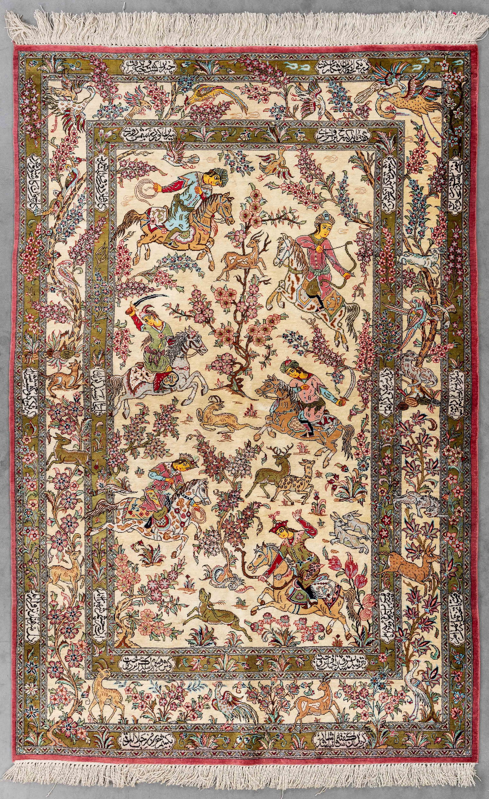 An Oriental hand-made carpet, silk, Ghoum, Iran (160 x 104 cm).: An Oriental hand-made carpet, silk, Ghoum, Iran (160 x 104 cm). With a figurative hunting decor. (104 x 160 x 0 cm)