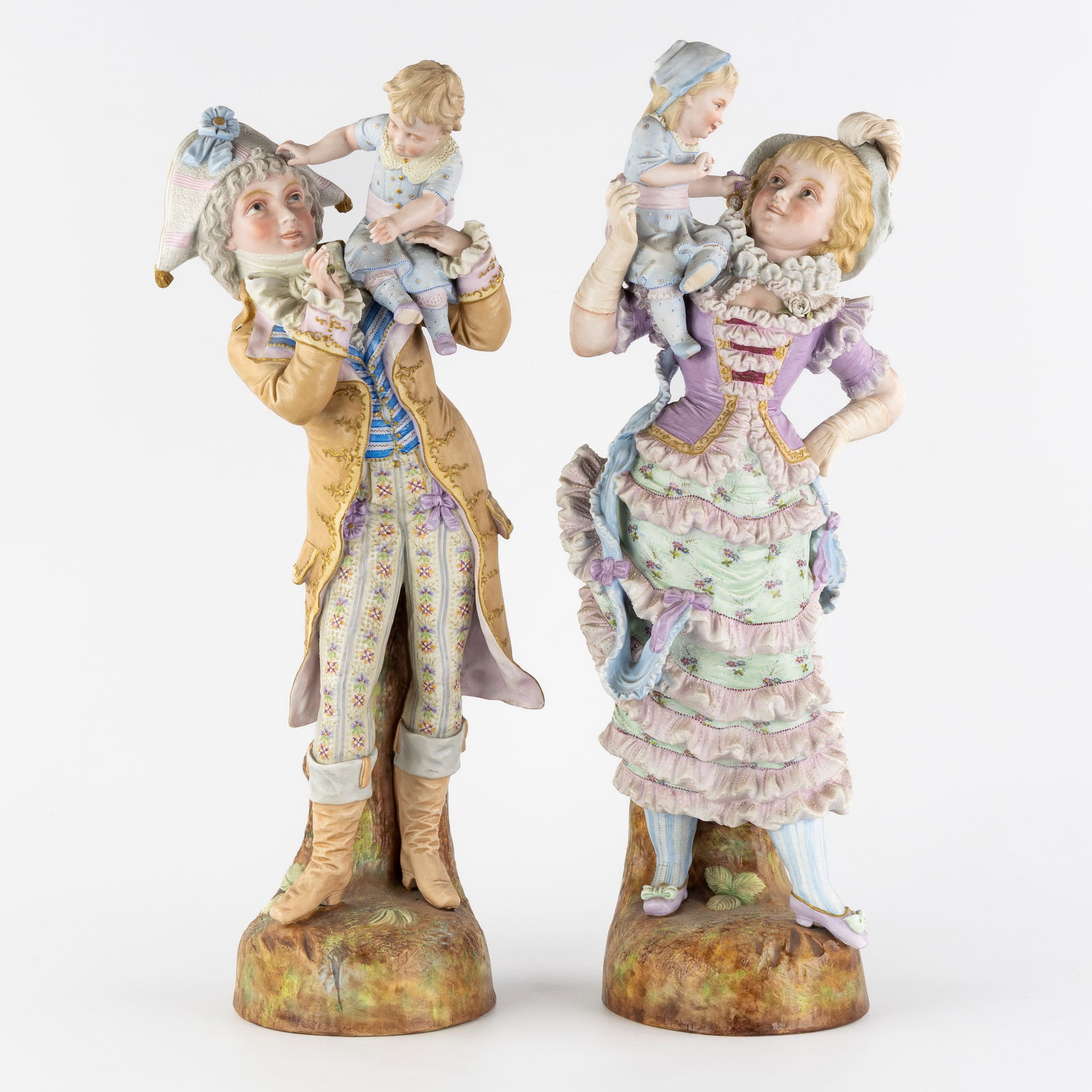 Vion & Baury, A Pair of large biscuit porcelain figurines, 'Father with Son' and 'Mother with: Vion & Baury, A Pair of large biscuit porcelain figurines, 'Father with Son' and 'Mother with Daughter', France, 19th century. Polychrome biscuit porcelain.Depicting a father with his son on his shoul
