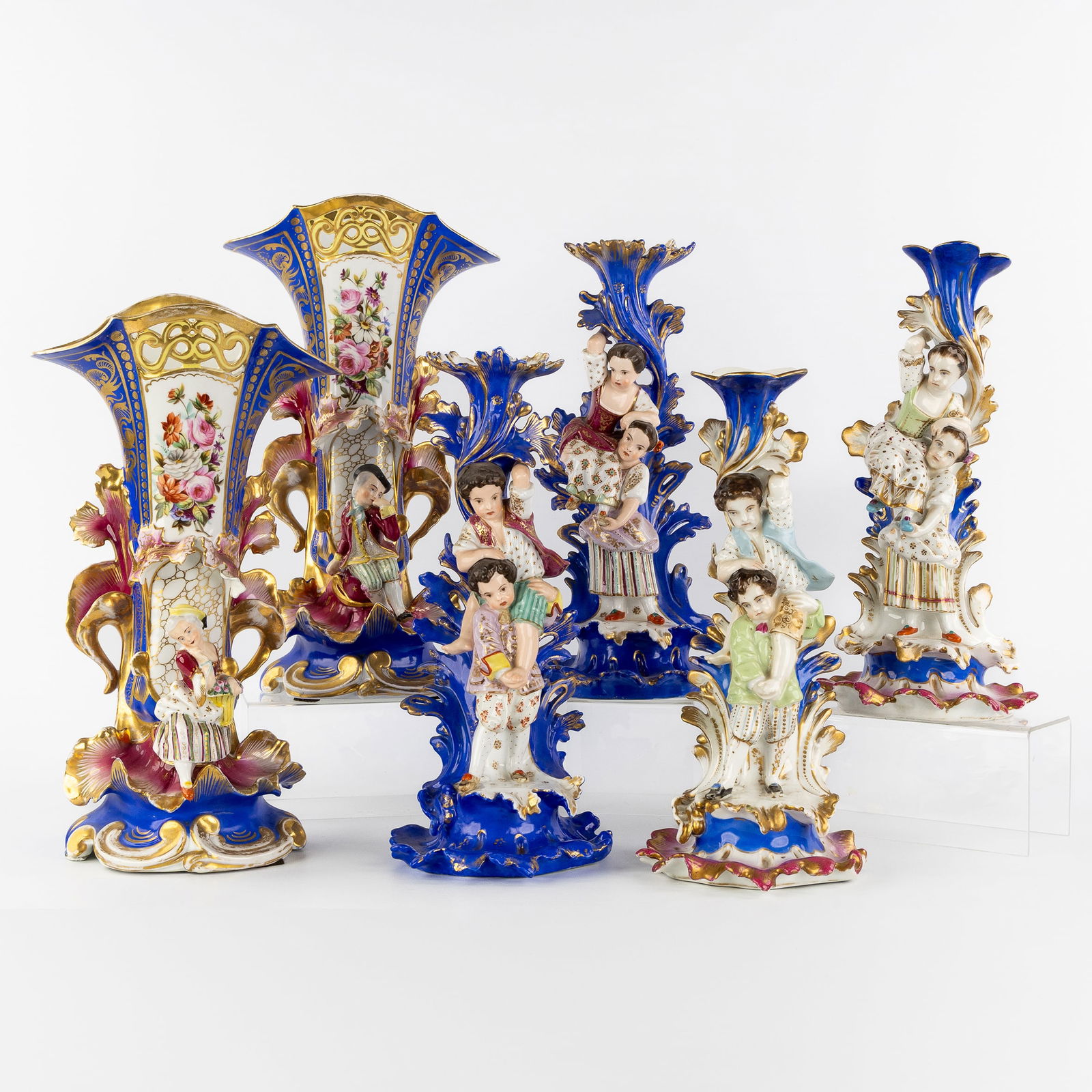 Vieux Paris, Two Pairs of candlesticks and a Pair of vases, polychrome and gilded porcelain, 19th C.: Vieux Paris, Two Pairs of candlesticks and a Pair of vases, polychrome and gilded porcelain, 19th century. Polychrome and gilded porcelain.A pair of candlesticks, with a blue ground, decorated with ch
