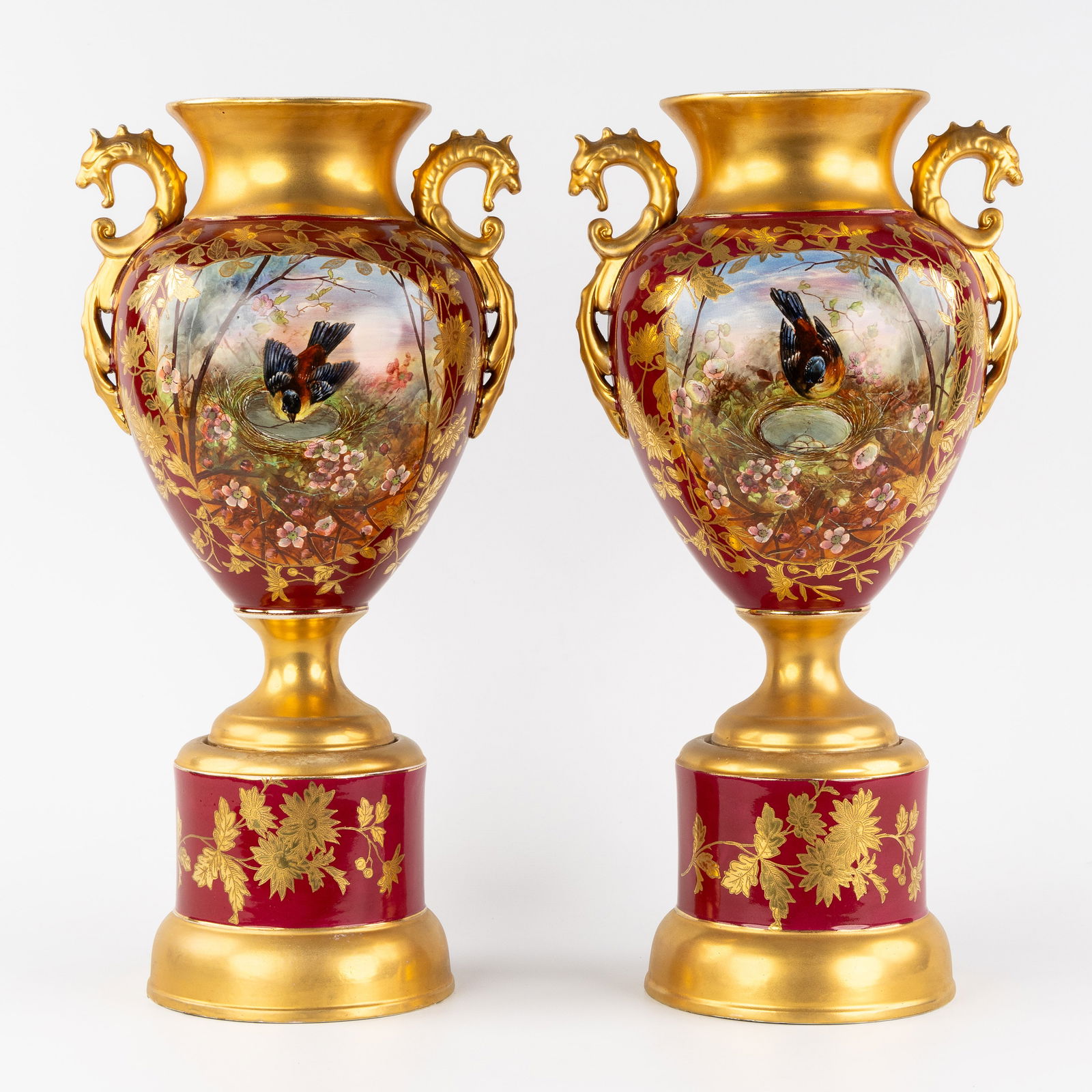 A Pair of Urns or Vases on a Stand, glazed faience, hand-painted and gilded decorations, 19th/20th: A Pair of Urns or Vases on a Stand, glazed faience, hand-painted and gilded decorations, 19th/20th century. Glazed faience.Vases or urns, mounted on a stand.Decorated with hand-painted landscapes of