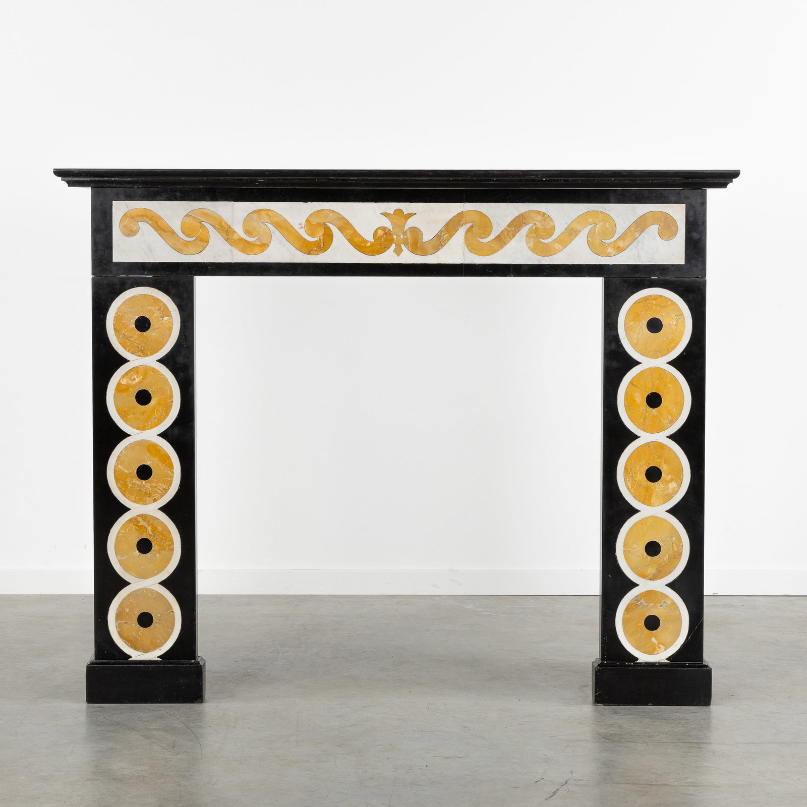 A decorative 'Intersia' or 'Pietra Dura' fireplace mantel. Marble. Circa 1940.: A decorative 'Intersia' or 'Pietra Dura' fireplace mantel. Marble. Circa 1940. Black marble inlaid with yellow and white marble in Geometric patterns and shapes. Probably Italian or French