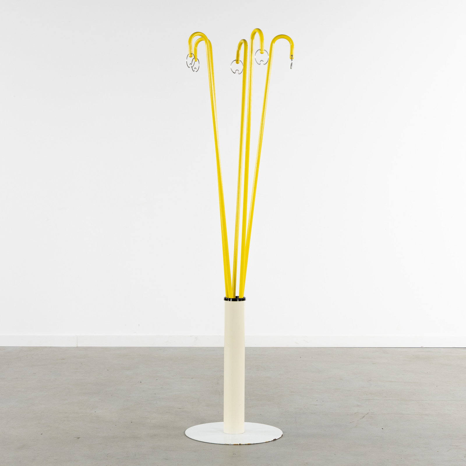 A Mid-Century Coat Rack, patinated metal, circa 1960.: A Mid-Century Coat Rack, patinated metal, circa 1960. Yellow and white patinated metal.Coat rack consisting of a base with five separate uprights, each with a coat hook. (40 x 162 x 0 cm)