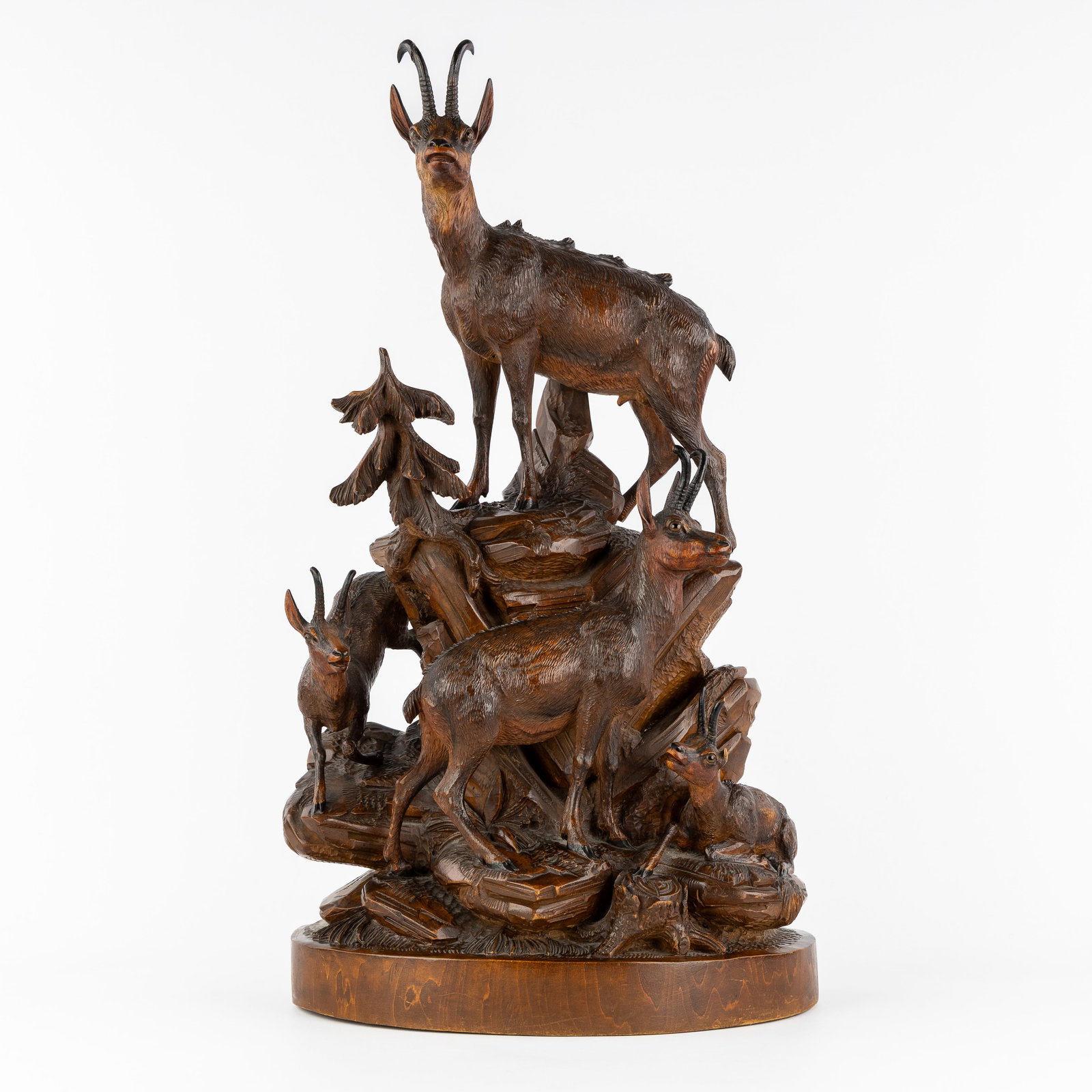 An Impressive wooden hunting sculpture, Chamois on a Rock, Black Forest, circa 1900.: An Impressive wooden hunting sculpture, Chamois on a Rock, Black Forest, circa 1900. Sculptured wood.Depicting four chamois on a rock.Finished with glass eyes. In the style