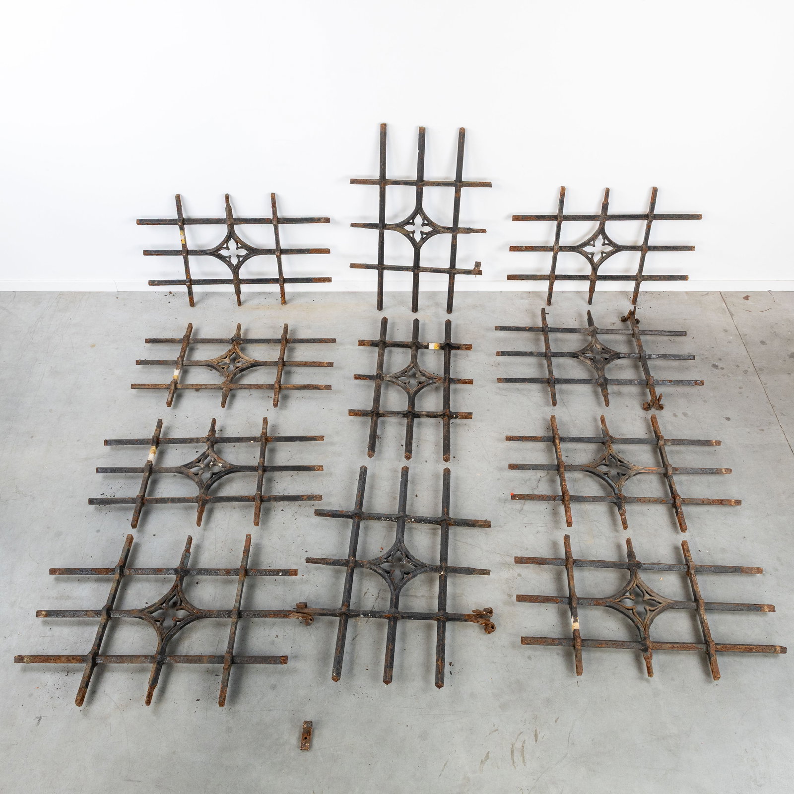 A Set of 11 antique wrought iron window grates or latticework, Flanders, Bruges.: A Set of 11 antique wrought iron window grates or latticework, Flanders, Bruges. Wrought iron.Decorated with Gothic tracery (four-leaf motif).Originating from Bruges. (72 x 104 x 0 cm)