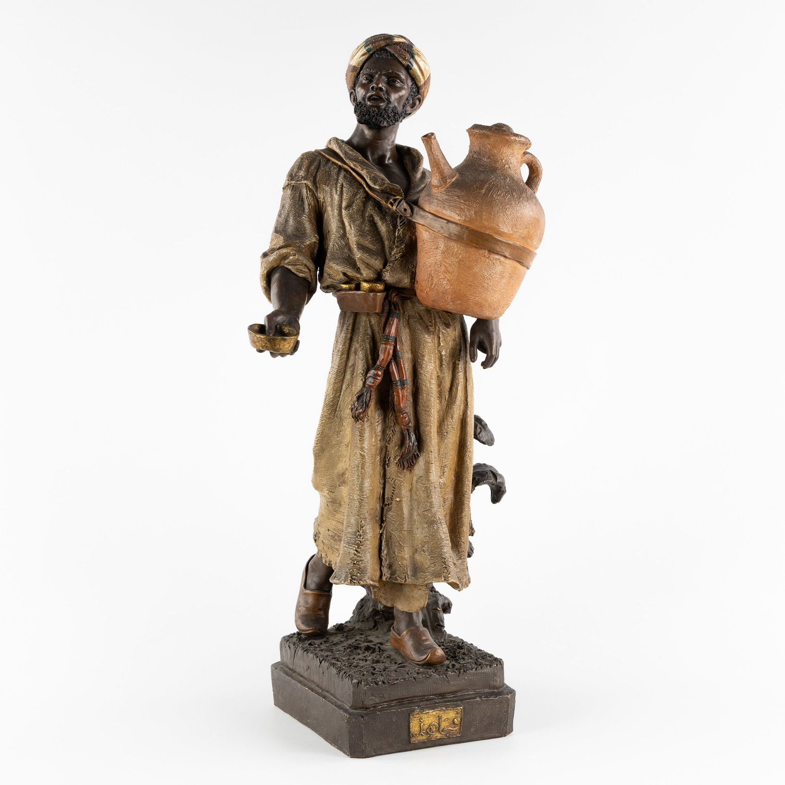 Friedrich Goldscheider (1845-1897) 'Moorish Salesman', patinated terracotta.: Friedrich Goldscheider (1845-1897) 'Moorish Salesman', patinated terracotta. Polychrome patinated terracotta.Representation of a Moorish syrup vendor.Signed on the bottom 'Fr. Goldscheider', numbere