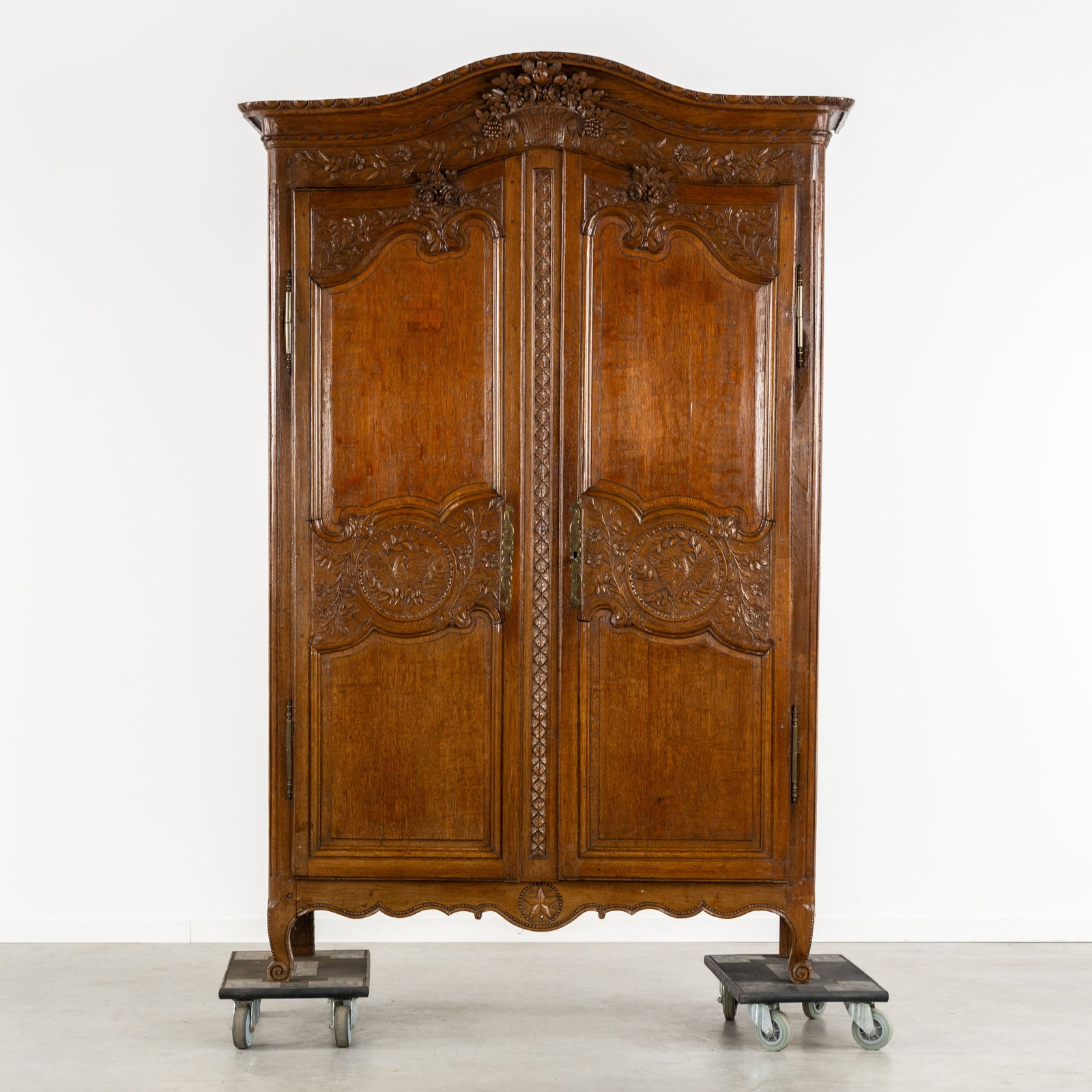 A Norman bridal or wedding cabinet, decorated with a sculptured fruit basket and doves, France, 19th: A Norman bridal or wedding cabinet, decorated with a sculptured fruit basket and doves, France, 19th century. Sculptured oak.Two-door bridal cabinet.Richly decorated with carved floral motifs, a fru