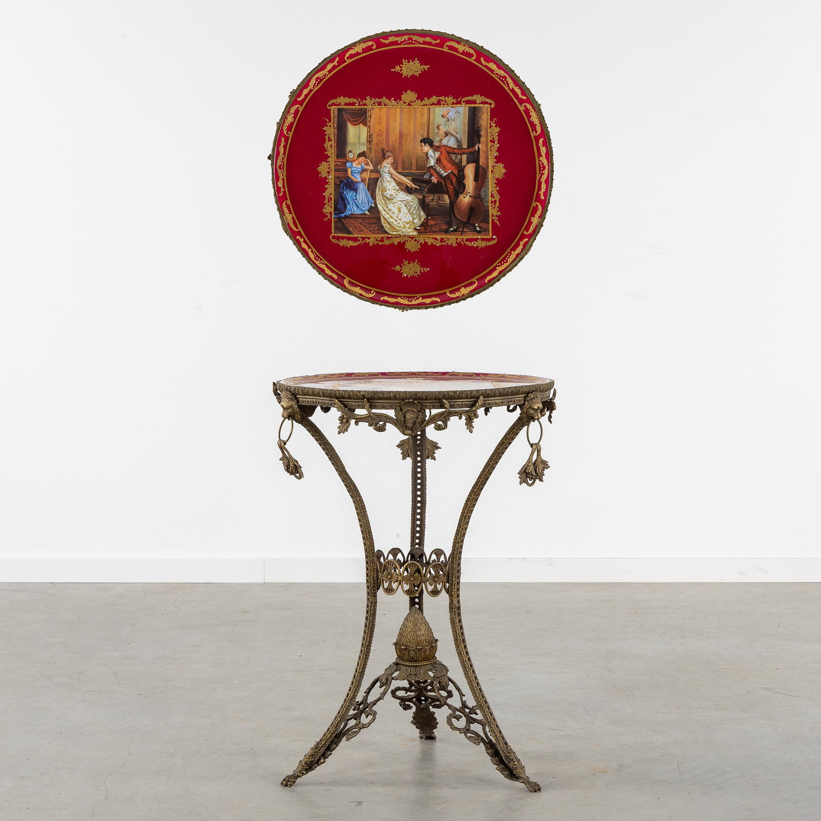 A Bronze Side table with a Porcelain top, decorated with lion heads.: A Bronze Side table with a Porcelain top, decorated with lion heads. Bronze and porcelain.Bronze tripod frame, decorated with lion heads, medallions, and a cone.Porcelain table top, decorated with a
