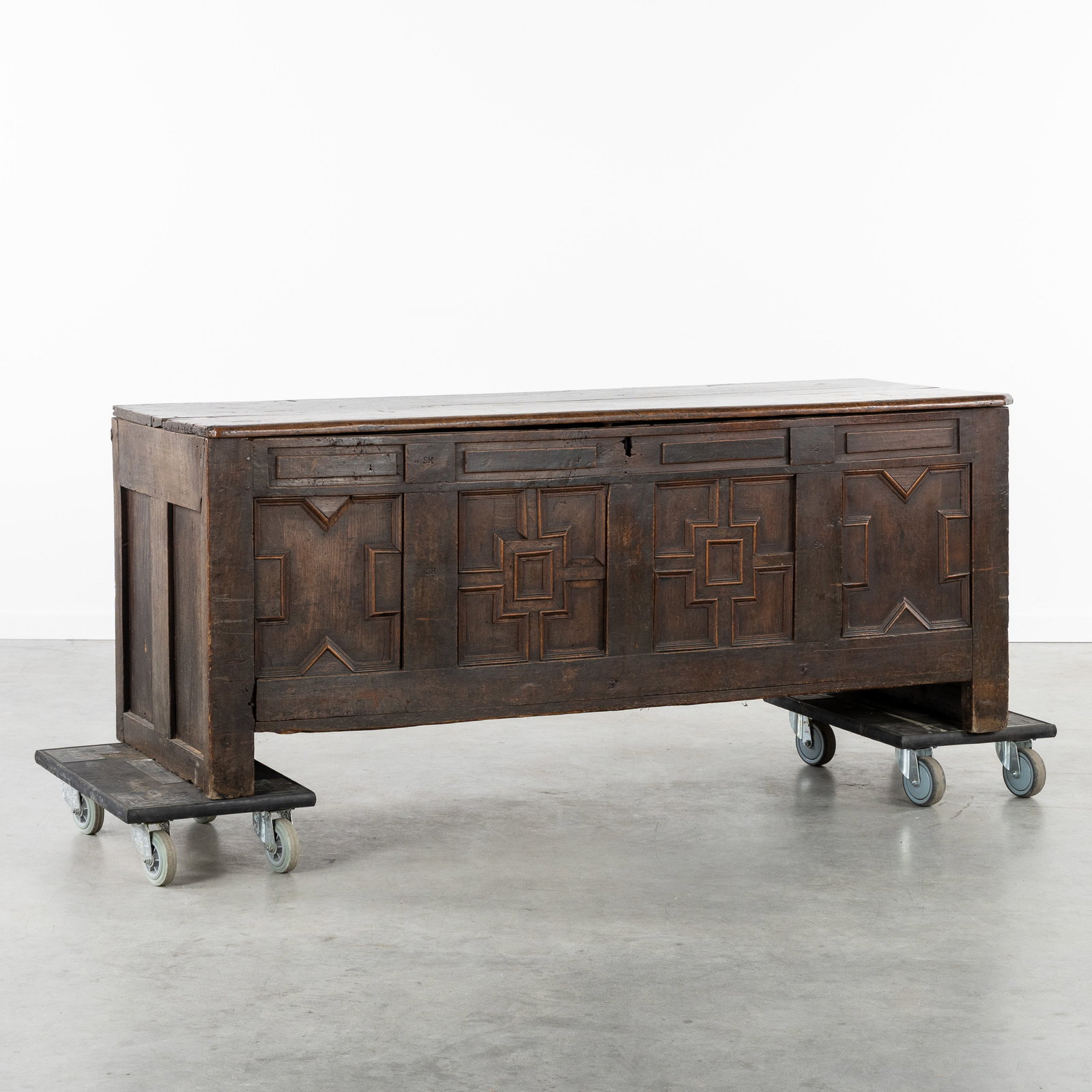 An Oak Blanket chest or Wedding chest, finished with Mitered work. 18th/19th C.: An Oak Blanket chest or Wedding chest, finished with Mitered work. 18th/19th century. Sculptured oak.The front is decorated with geometric mitered work.With monograms SH and HS. (166 x 66 x