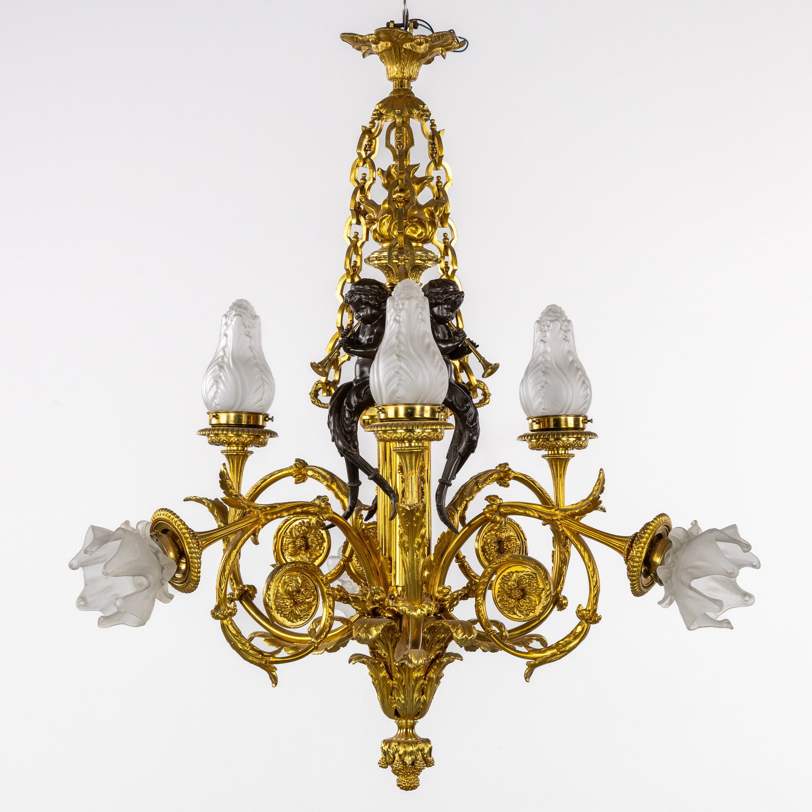 A Chandelier, Decorated with musical Putti or Amours, gilt and patinated bronze, France, circa: A Chandelier, Decorated with musical Putti or Amours, gilt and patinated bronze, France, circa 1900-1920. Gilded and patinated bronze, and fros