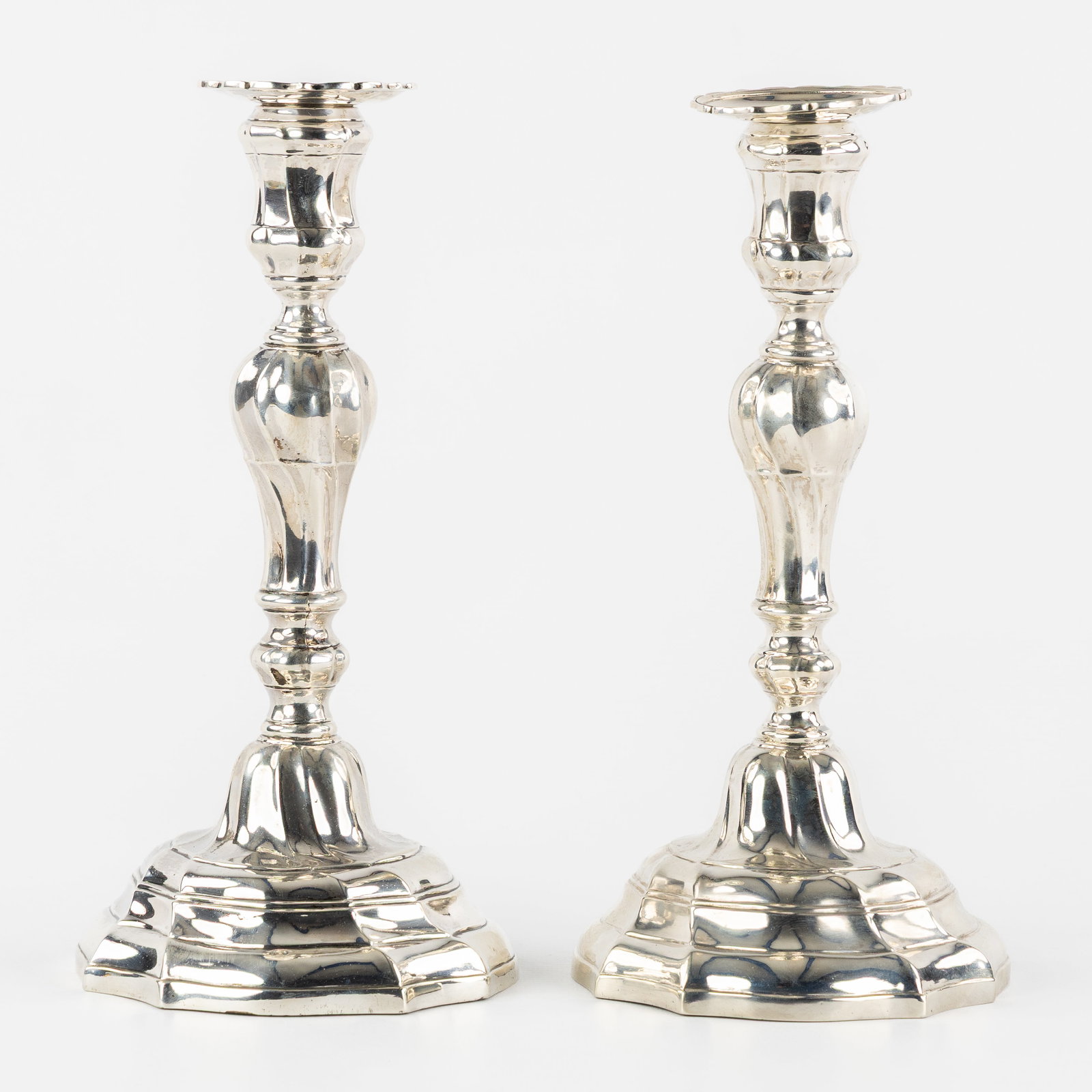 A Pair of silver candlesticks, Louis XV period, Ath, 1763 & 1764. Silver, 720g. (1 of 9)