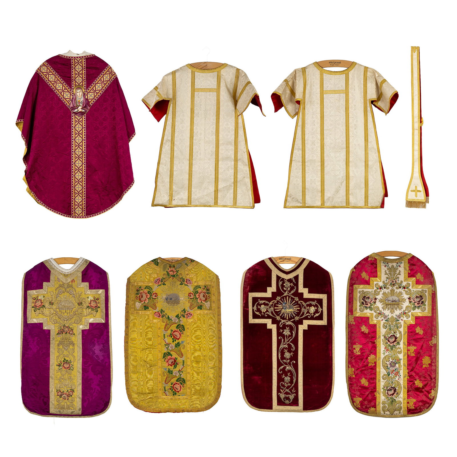 Lithurgical Vestments: A collection of 7 chasubles and dalmatics, made of thick gold brocade and: Lithurgical Vestments: A collection of 7 chasubles and dalmatics, made of thick gold brocade and featuring embroidery. A pair of dalmatics finished with floral designs woven into the fabric. A Ro