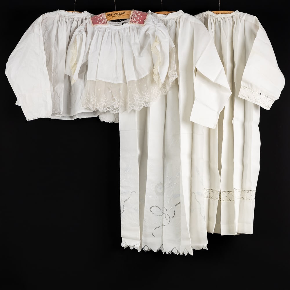 Lithurgical Vestments: Two albs and two altar servers’ robes, finished with lace.: Lithurgical Vestments: Two albs and two altar servers’ robes, finished with lace. Hand-sewn lace featuring a crucifix and floral motifs. The others are finished with lace featuring