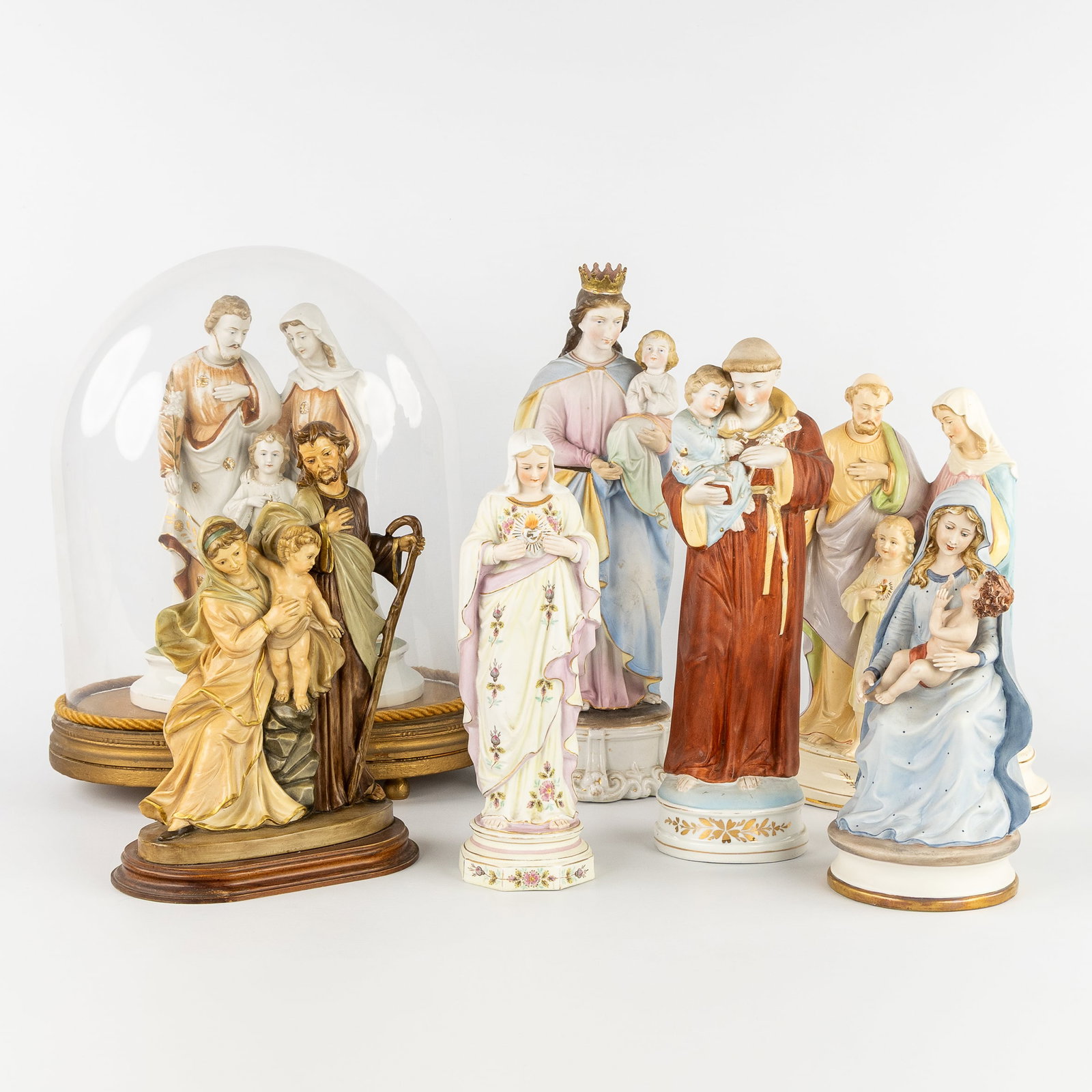 A Collection of 7 saint statues, Holy Family, Anthony of Padua, and others. Resin, porcelain, and (1 of 5)