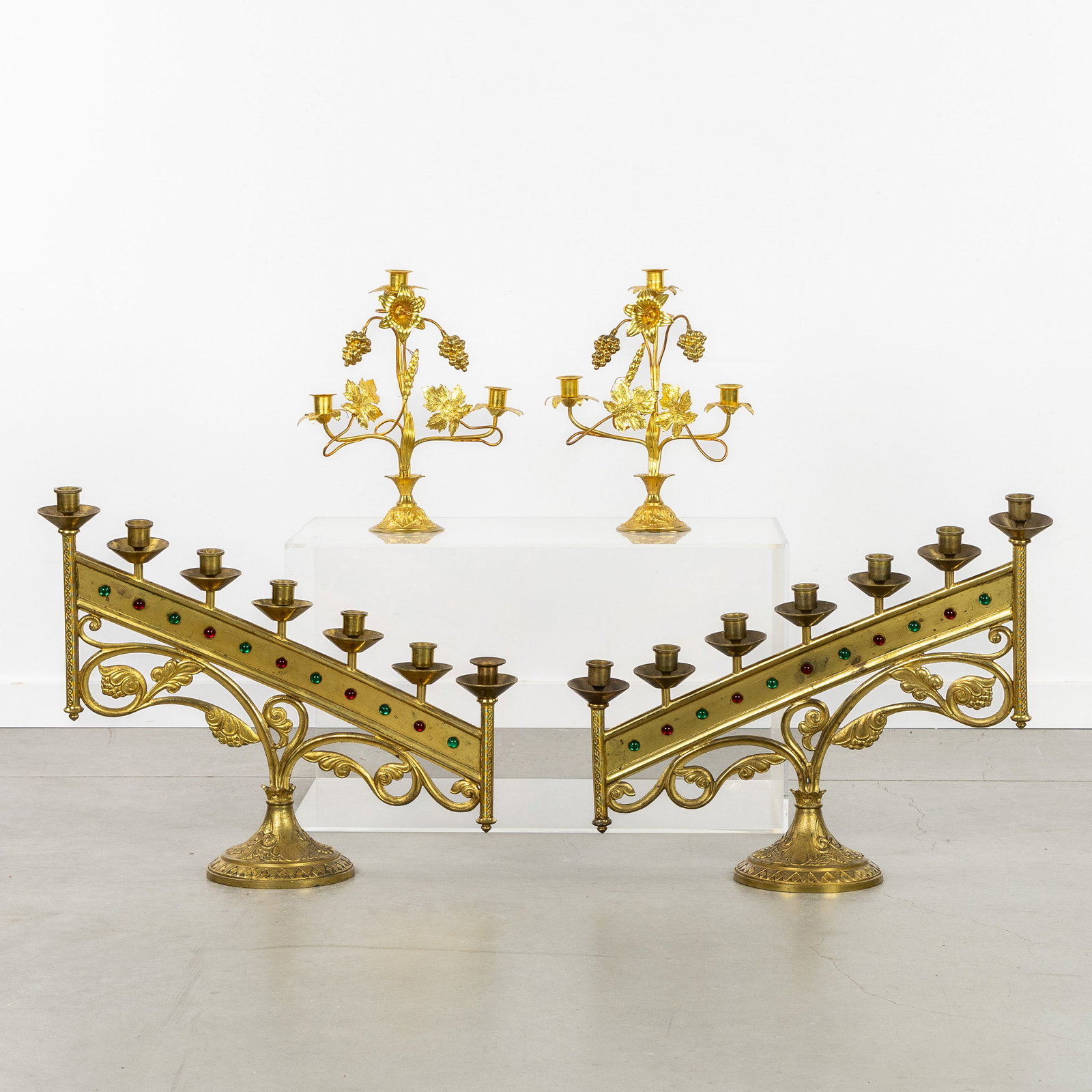 Two Pairs of church candelabra, gilded bronze and brass, with grapevines, lilies, and cabochons,: Two Pairs of church candelabra, gilded bronze and brass, with grapevines, lilies, and cabochons, Gothic Revival. Gilded bronze and brass.Pair of church candelabra with 7 candle holders, finished with