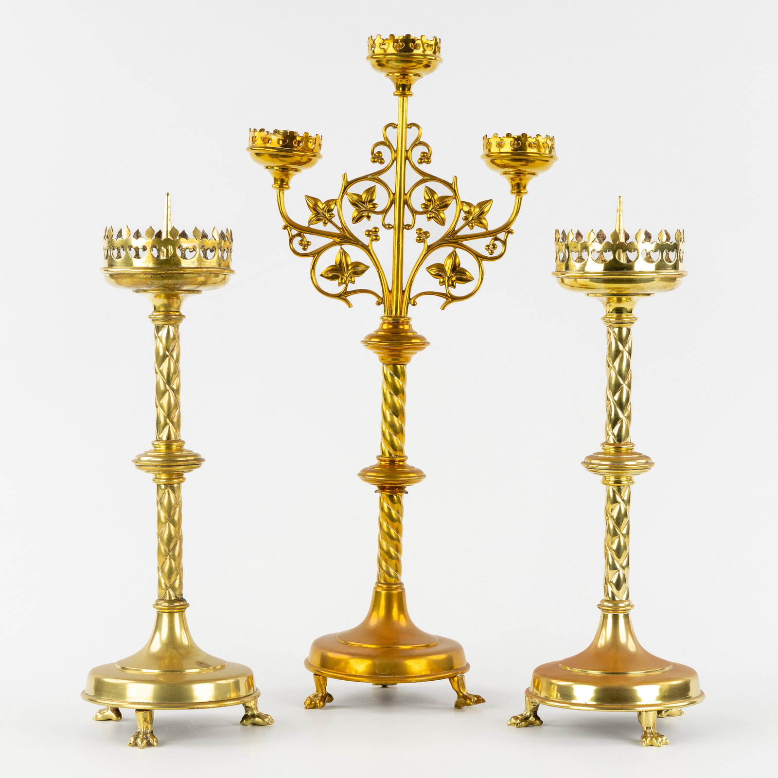 A Pair of church candlesticks and a three-armed church candelabra with vines, gilded brass, Gothic (1 of 6)