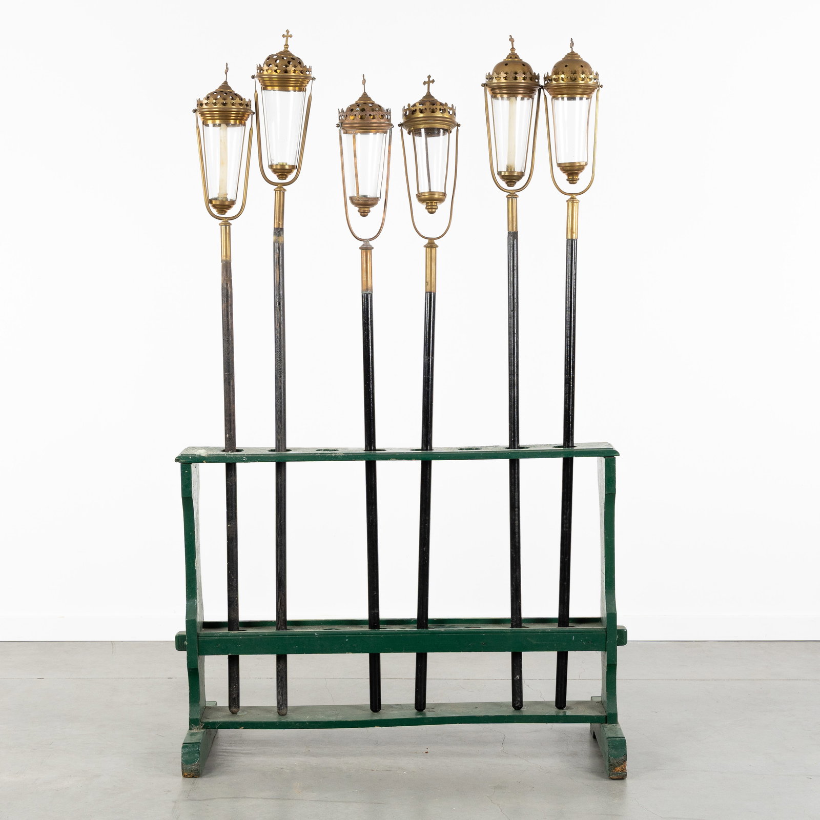 Six Processional Lanterns or Flambées, brass and glass, Gothic Revival, in a patinated wooden stand (1 of 4)