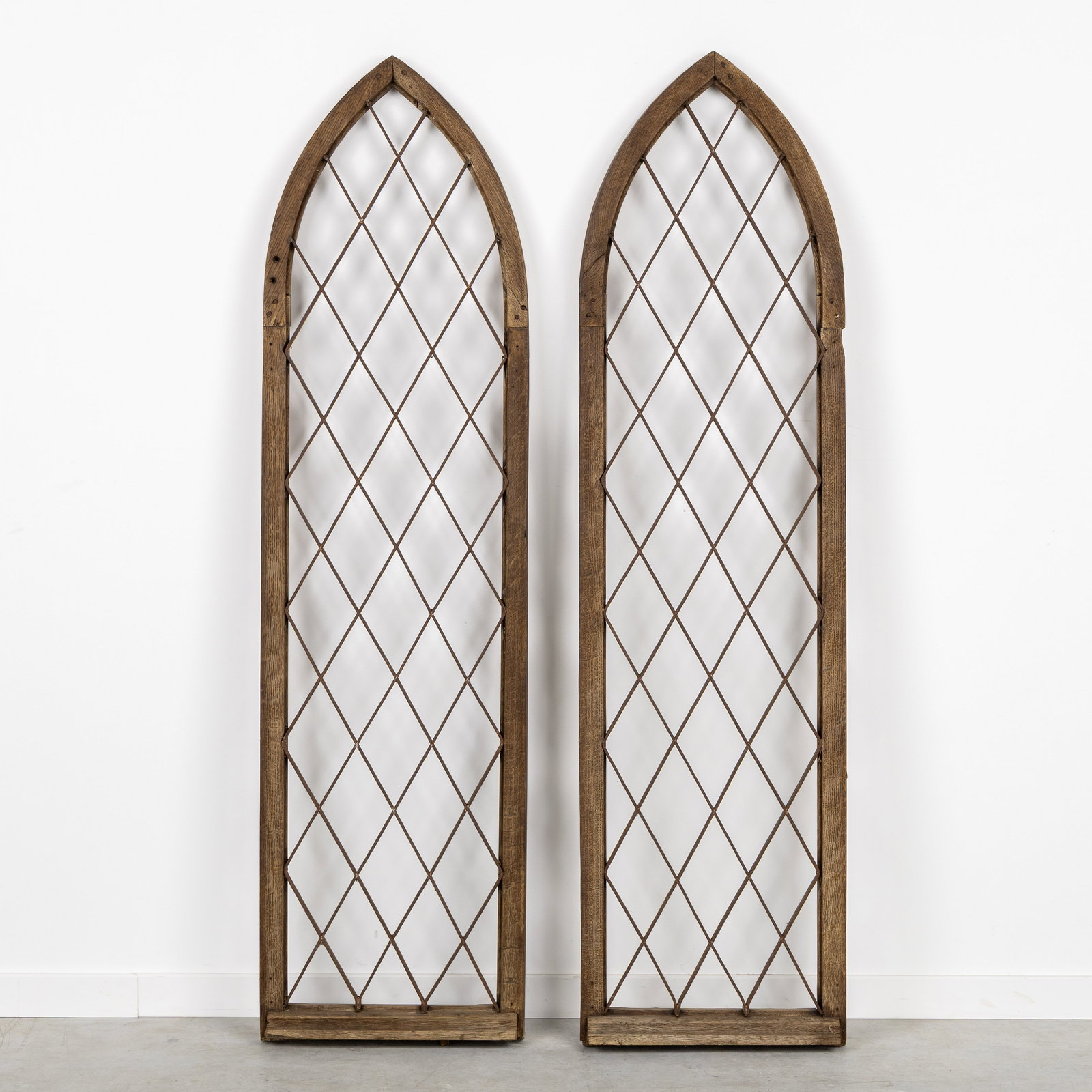 A pair of antique, Gothic Revival windows, circa 1900.: A pair of antique, Gothic Revival windows, circa 1900. Wood and metal. (40 x 150 x 0 cm)