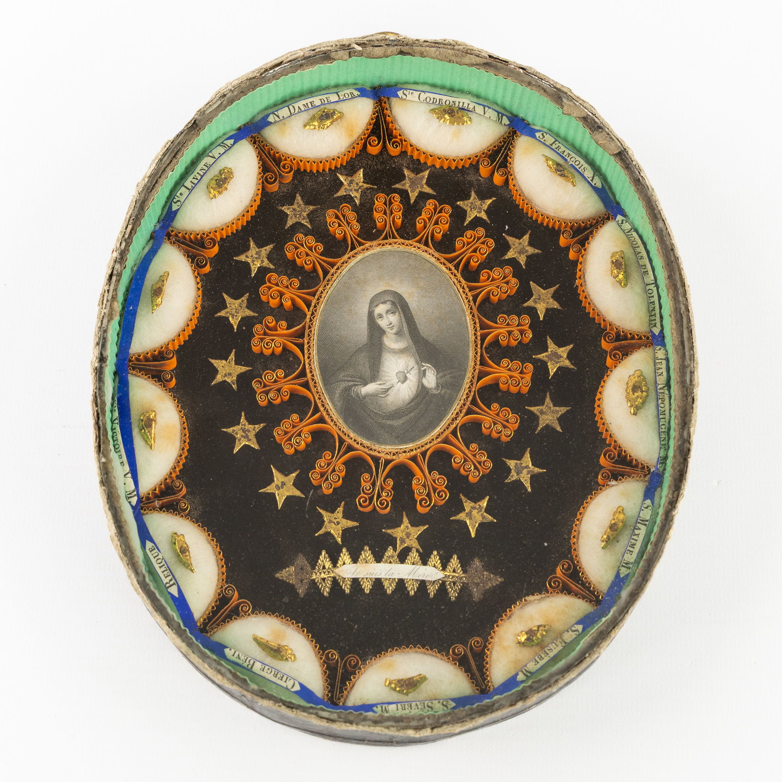 A Reliquary frame with 13 relics for Saints and Martyrs, Folk Art.: A Reliquary frame with 13 relics for Saints and Martyrs, Folk Art. Reliquary frame, decorated with paper filigree work and an image of the Virgin Mary with the Immaculate Heart. With relics for: Saint