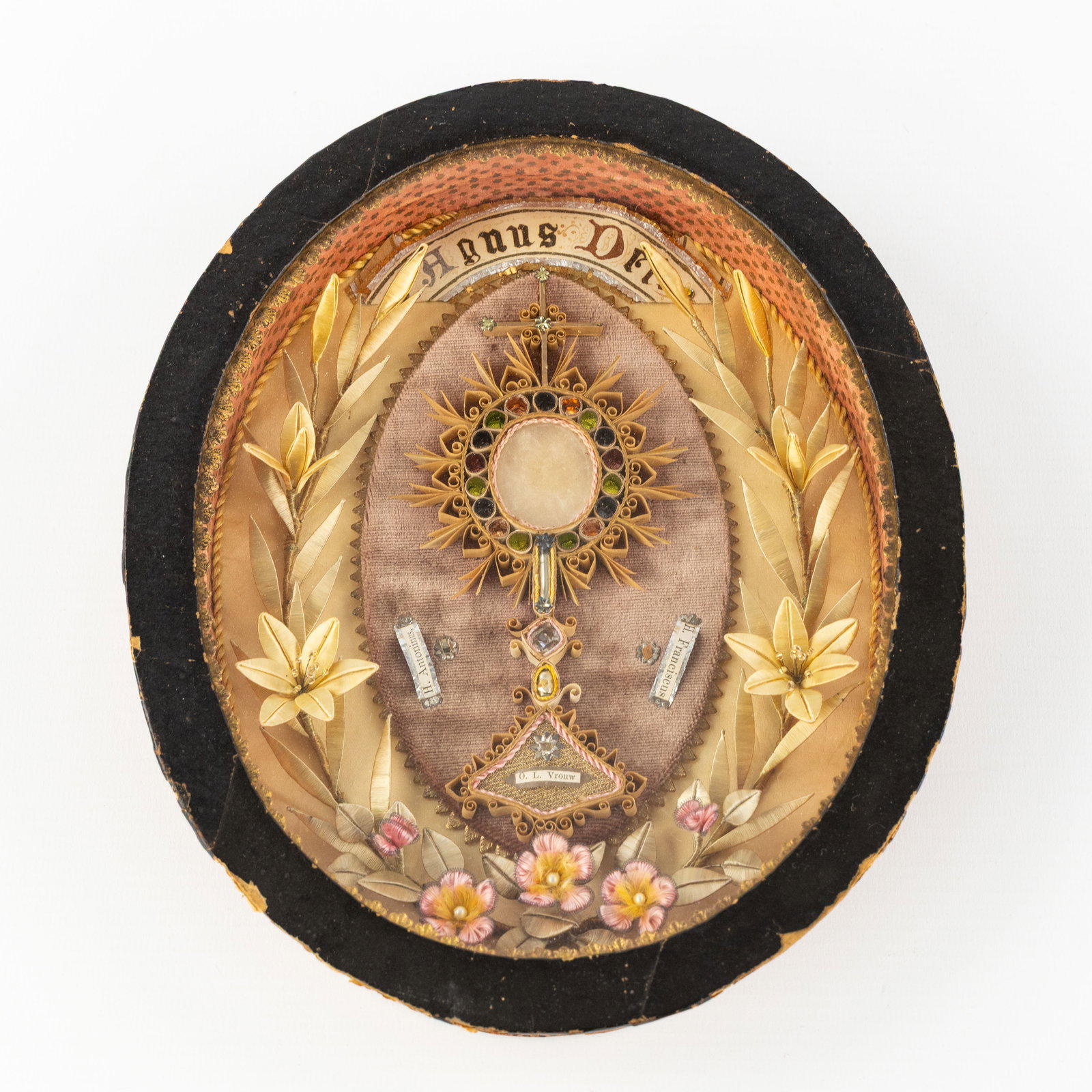 An Oval Reliquary Frame with Agnus Dei and Relics for Our Lady, Saint Anthony and Saint Francis. (1 of 5)