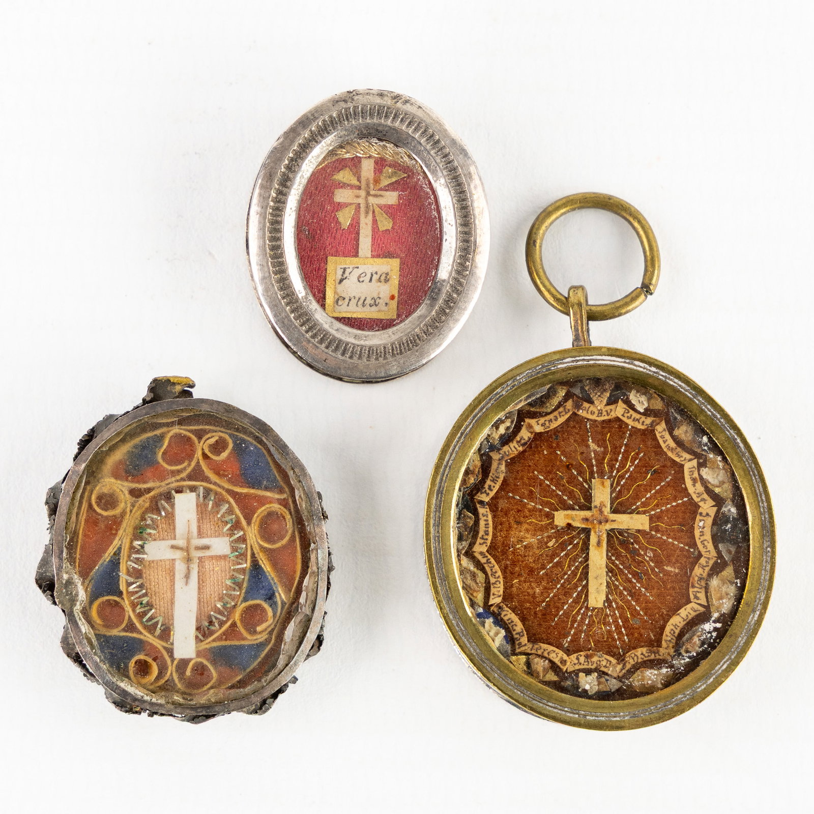 Three sealed theca or reliquary pendants with relics for the True Cross, De Ligno SS Crucis DNJC. (1 of 2)