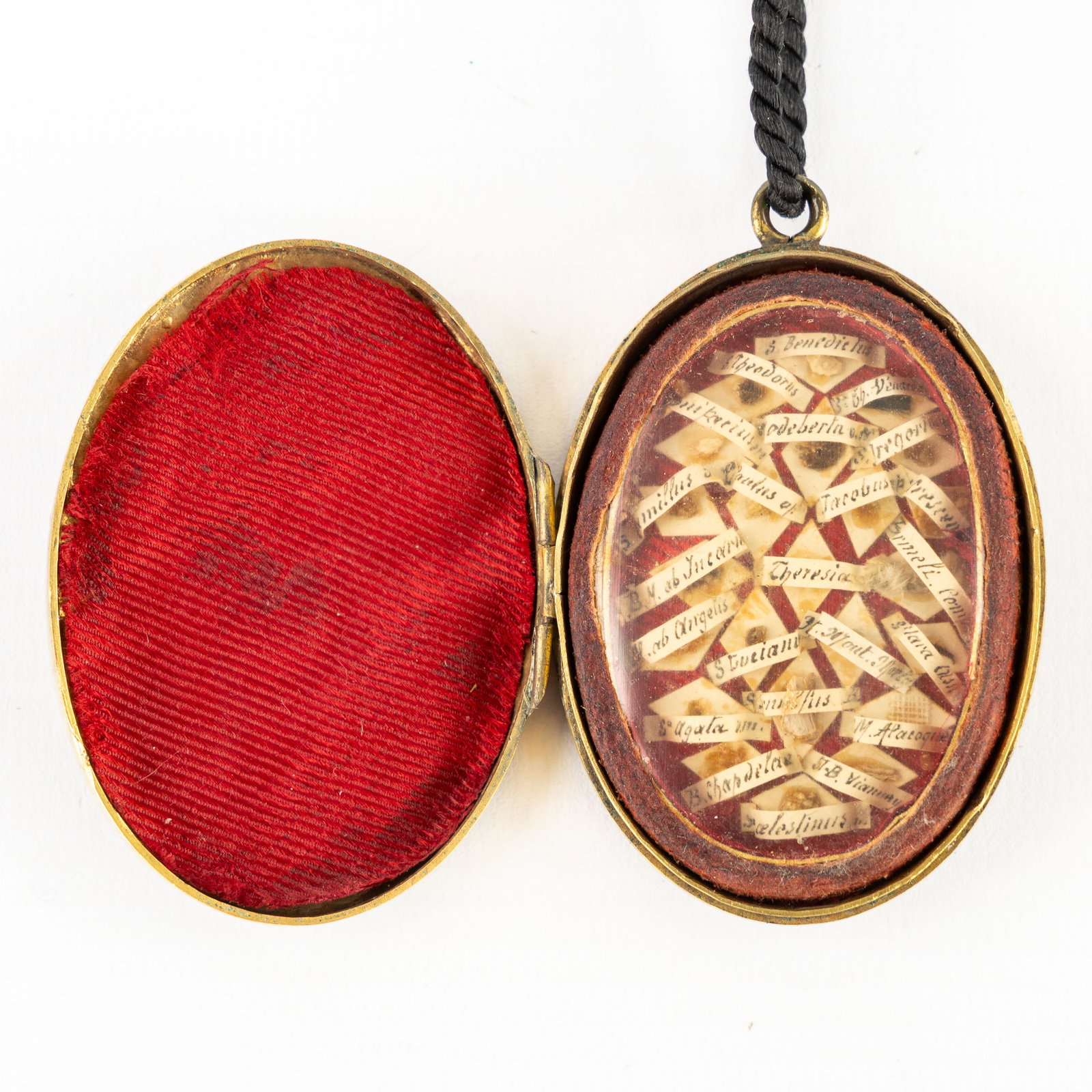 A sealed multi-theca in a brass pendant, with relics for Saints and Apostles, including the (1 of 5)