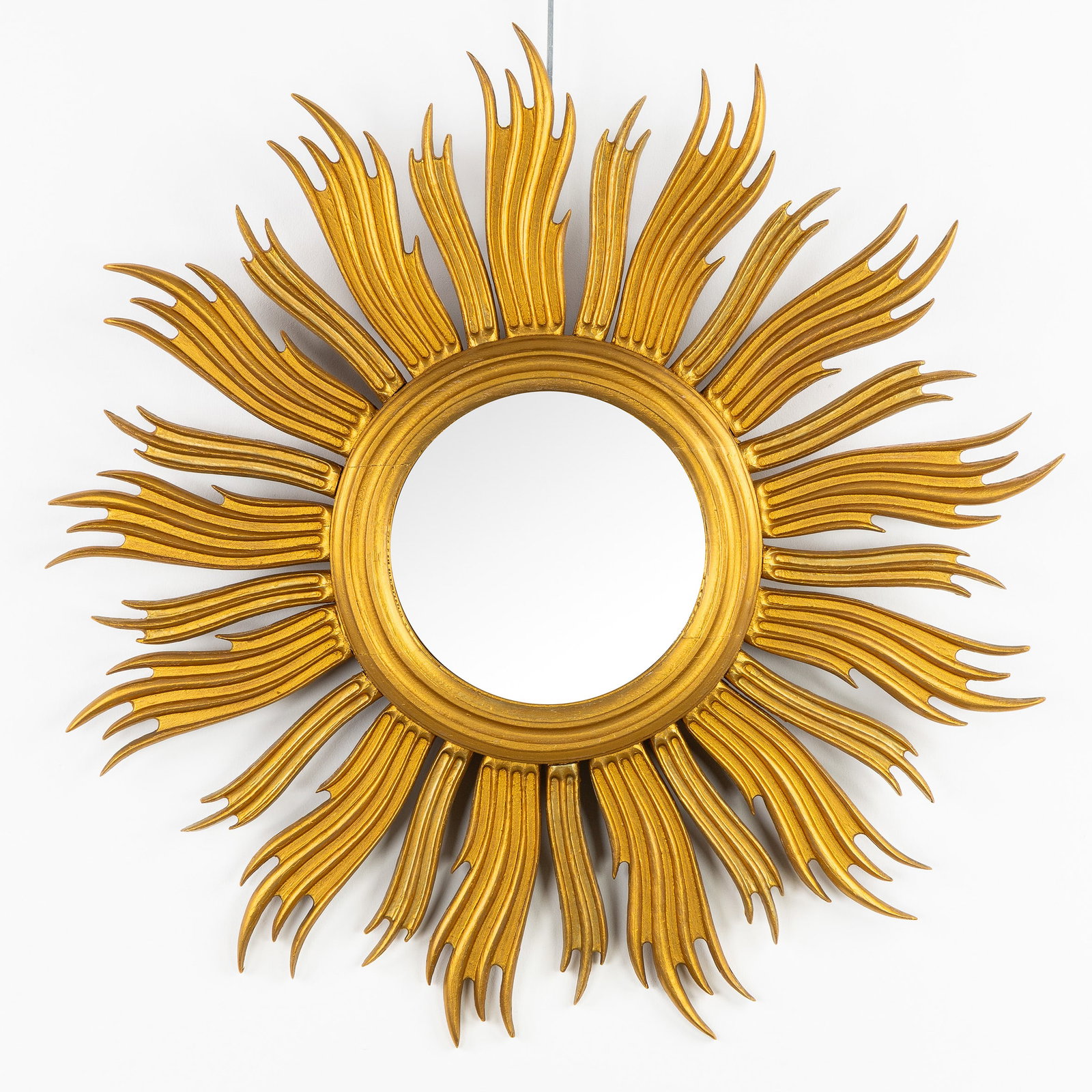 A Mid-Century Sunburst Mirror, Gilt wood, Convex Glass. Circa 1970.: A Mid-Century Sunburst Mirror, Gilt wood, Convex Glass. Circa 1970. Convex glass.Gilt wood.Circa 1970. Dimensions: (W:63 cm) The absence of a condition report does not imply a perfect item. Please sen