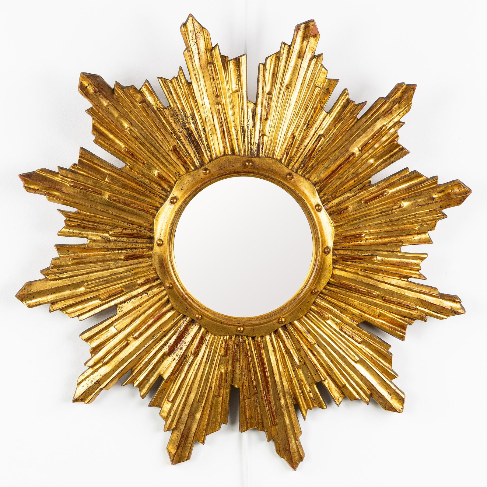 A Mid-Century Sunburst Mirror, Gilded, Convex Glass. Circa 1970.: A Mid-Century Sunburst Mirror, Gilded, Convex Glass. Circa 1970. Convex glass.Gilded resin.Circa 1970. Dimensions: (W:65 cm) The absence of a condition report does not imply a perfect item. Please sen