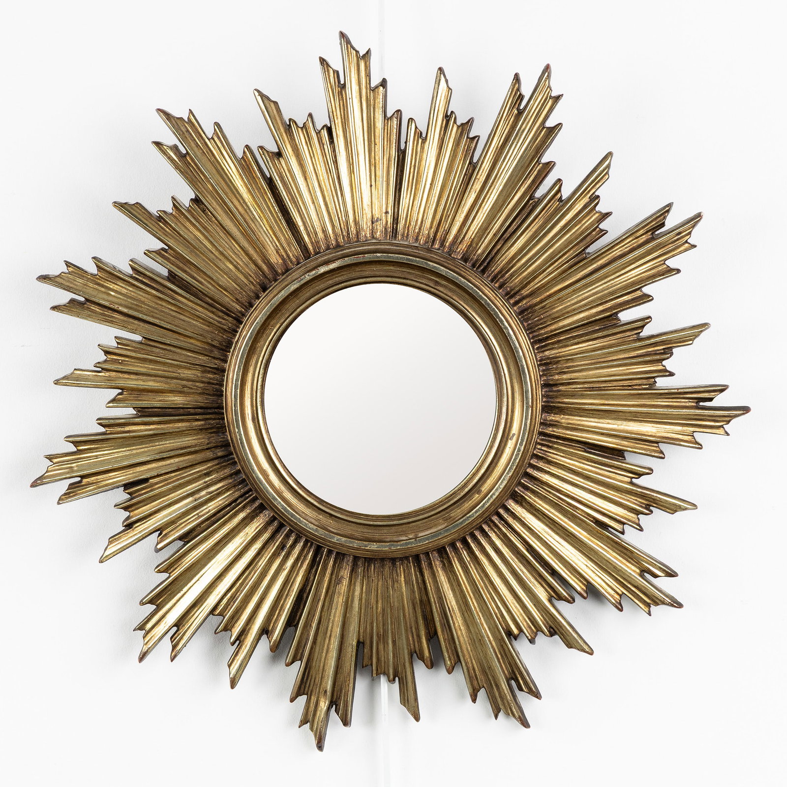 A Mid-Century Sunburst Mirror, Gilded, Convex Glass. Circa 1970.: A Mid-Century Sunburst Mirror, Gilded, Convex Glass. Circa 1970. Convex glass.Gilded resin.Circa 1970. Dimensions: (W:46 cm) The absence of a condition report does not imply a perfect item. Please sen