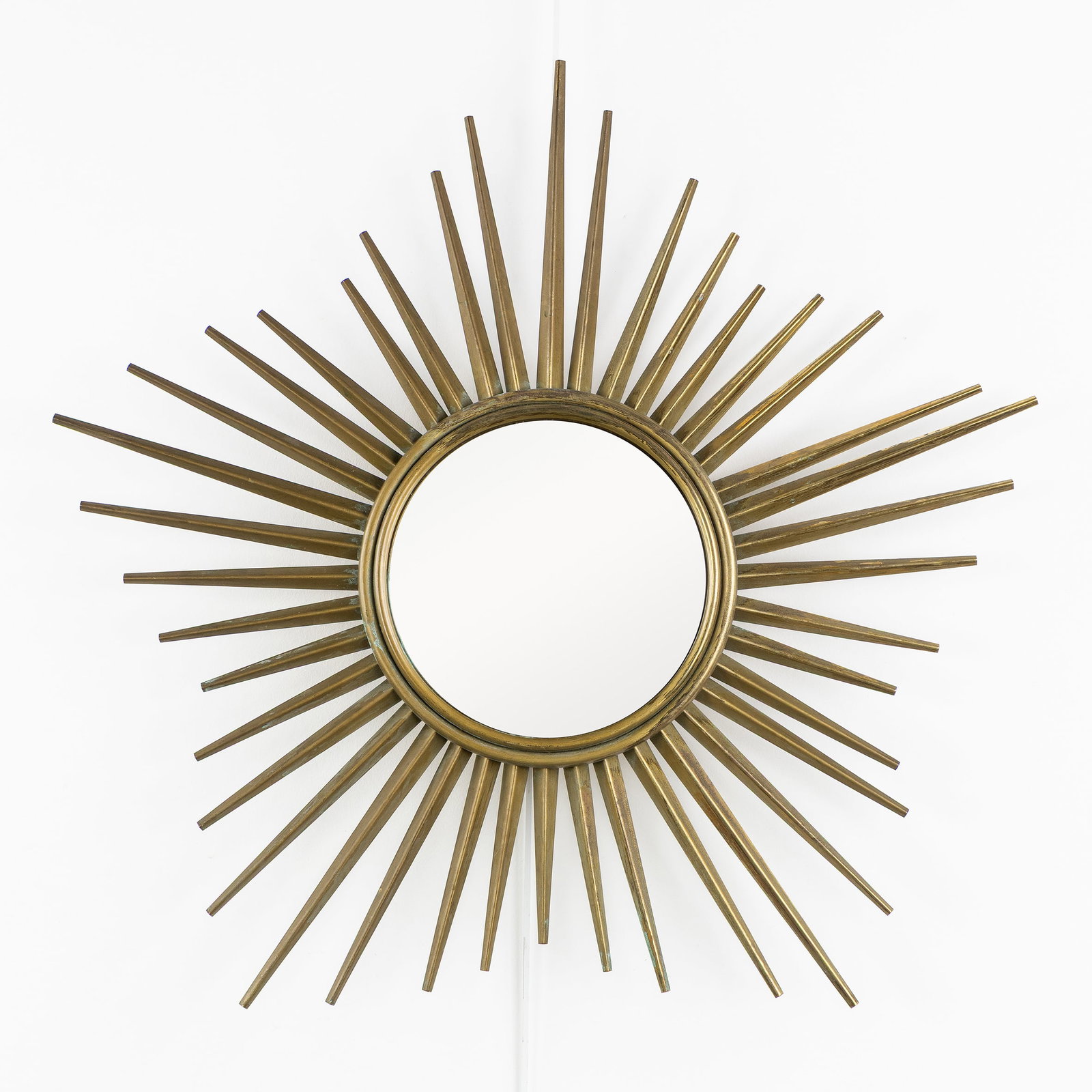A Mid-Century sunburst mirror, gilded metal, Convex Glass. Circa 1970.: A Mid-Century sunburst mirror, gilded metal, Convex Glass. Circa 1970. Convex glass.Gilded metal.In the style of Chaty Vallauris.Circa 1970. Dimensions: (W:65 cm) The absence of a condition report doe