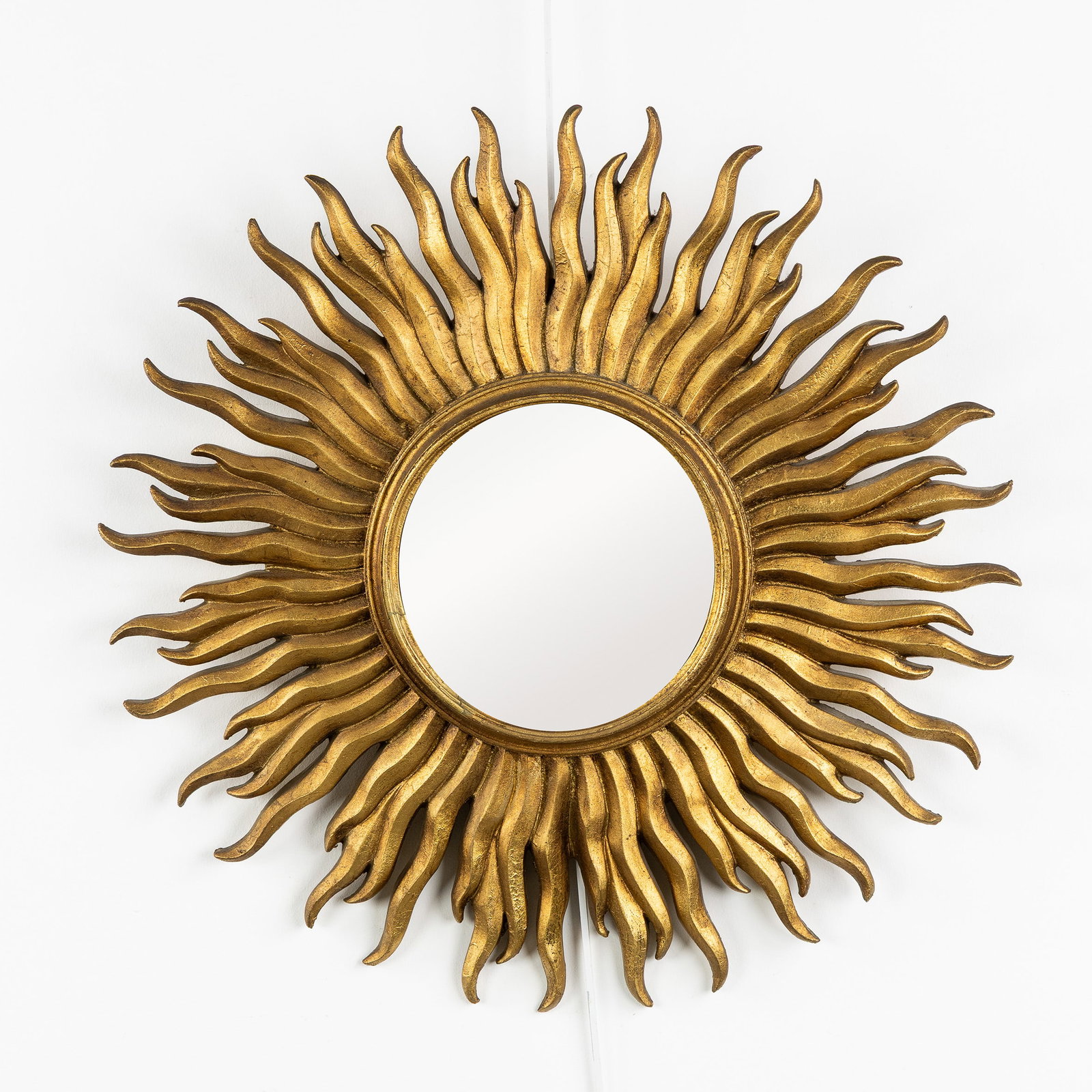 A Mid-Century Sunburst Mirror, Gilded, Convex Glass. Circa 1970.: A Mid-Century Sunburst Mirror, Gilded, Convex Glass. Circa 1970. Convex glass.Gilded resin.Circa 1970. Dimensions: (W:52 cm) The absence of a condition report does not imply a perfect item. Please sen