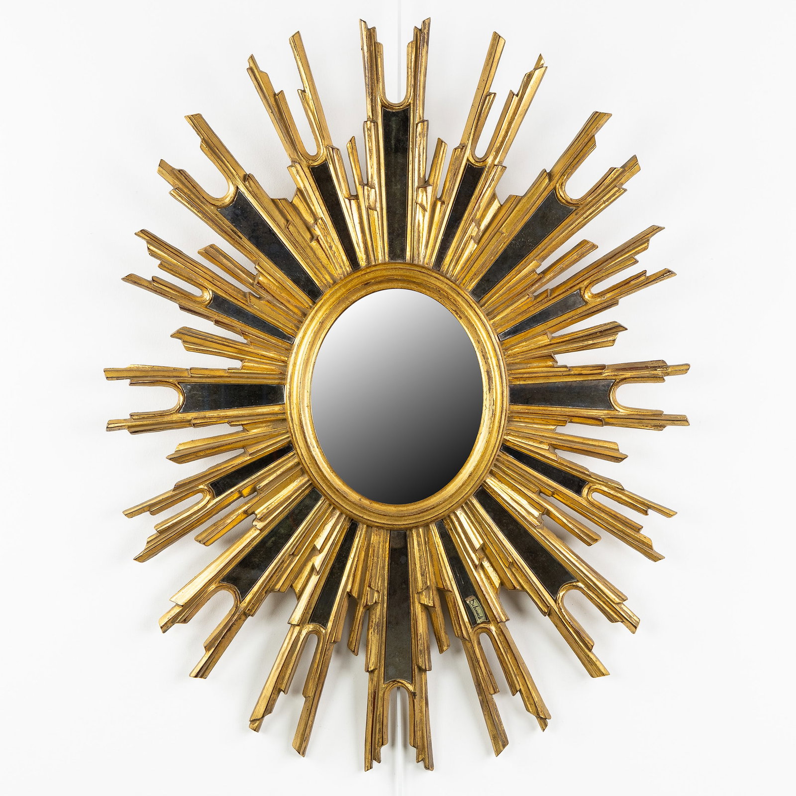 Deknudt, a Large Oval Mid-Century Sunburst mirror, gilded, convex glass. Circa 1970.: Deknudt, a Large Oval Mid-Century Sunburst mirror, gilded, convex glass. Circa 1970. Convex glass.Gilded resin.Circa 1970. Dimensions: (W:66 x H:84 cm) The absence of a condition report does not imply