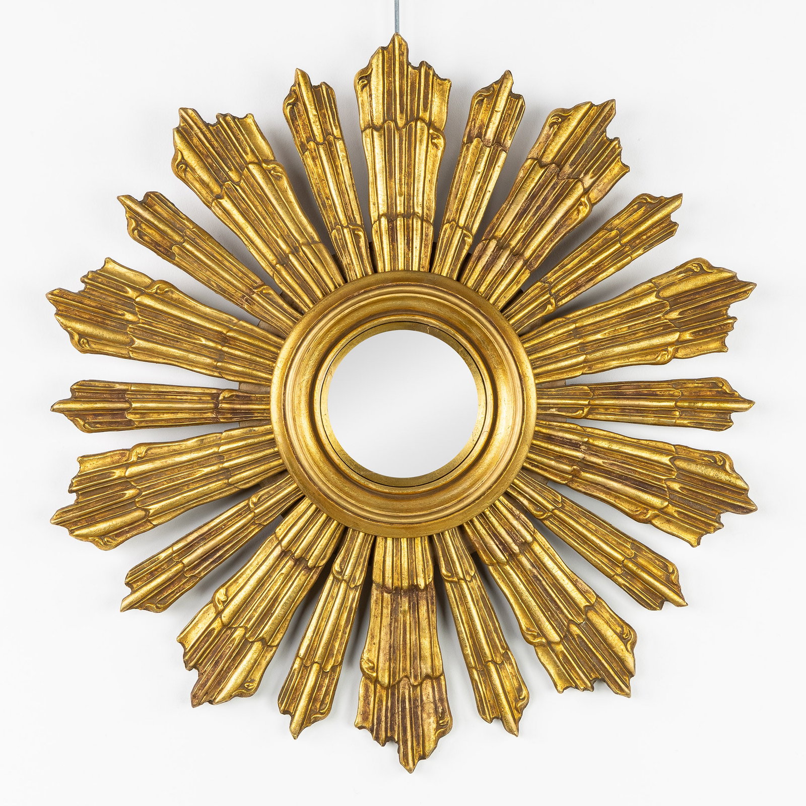 Deknudt, A Mid-Century Sunburst Mirror, Gild and sculptured wood, Convex Glass. Circa 1970.: Deknudt, A Mid-Century Sunburst Mirror, Gild and sculptured wood, Convex Glass. Circa 1970. Convex glass.Gilt wood.Circa 1970. Dimensions: (W:59 cm) The absence of a condition report does not imply a 
