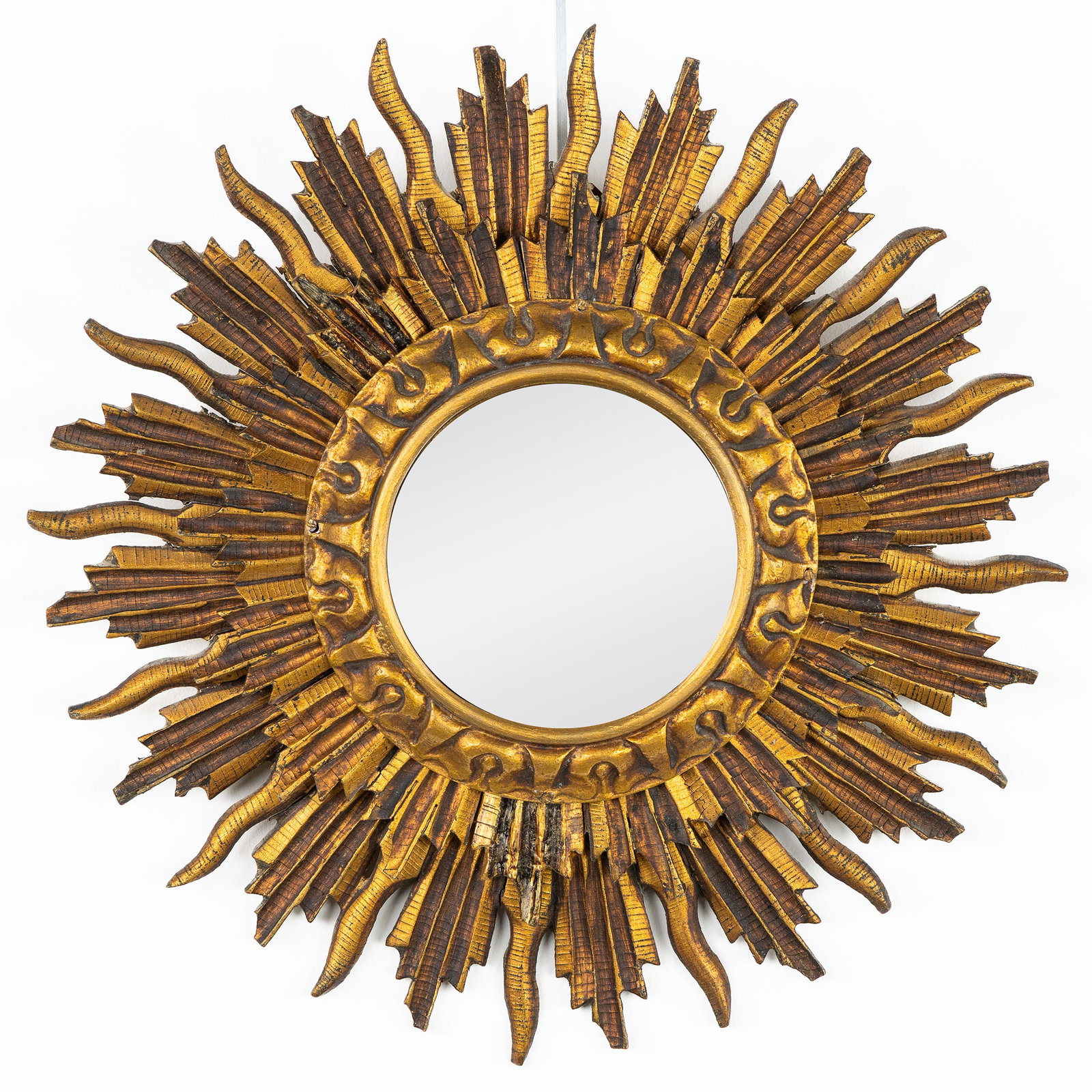 A Mid-Century double Sunburst Mirror, Gilt and sculptured wood, Convex Glass. Circa 1970.: A Mid-Century double Sunburst Mirror, Gilt and sculptured wood, Convex Glass. Circa 1970. Convex glass.Gilt and sculptured wood.Circa 1970. Dimensions: (W:34 cm) The absence of a condition report does